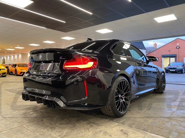 BMW M2 F87 carbon fiber diffuser by CT Carbon, V3 style, showcasing sleek aerodynamic design and high-quality carbon fiber finish.