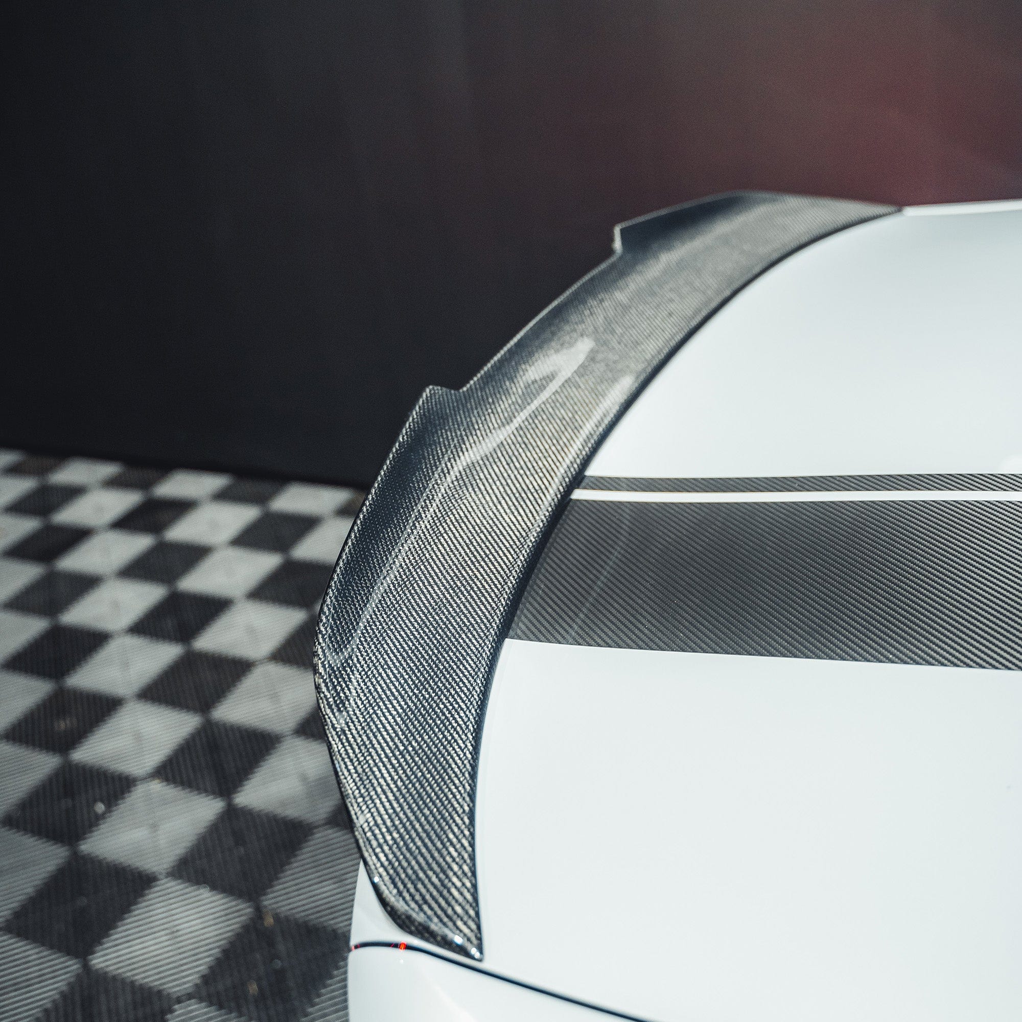 BMW M2 F87 and F22 carbon fibre ducktail spoiler by CT Carbon, showing sleek aerodynamic design on the car's rear.