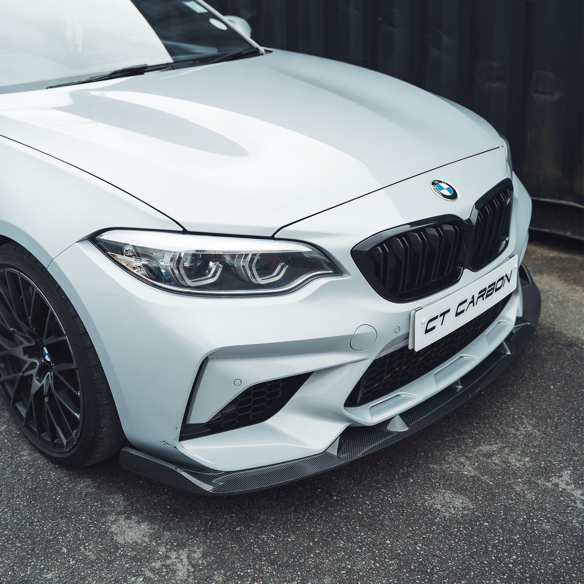 BMW M2C F87 carbon fibre splitter V2 by CT Carbon, showing sleek 3D-style design attached to the front bumper.