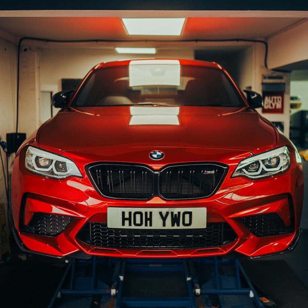 BMW M2/M2C F87 carbon fibre splitter by CT Carbon, V1 style, showing sleek design and aerodynamic features.