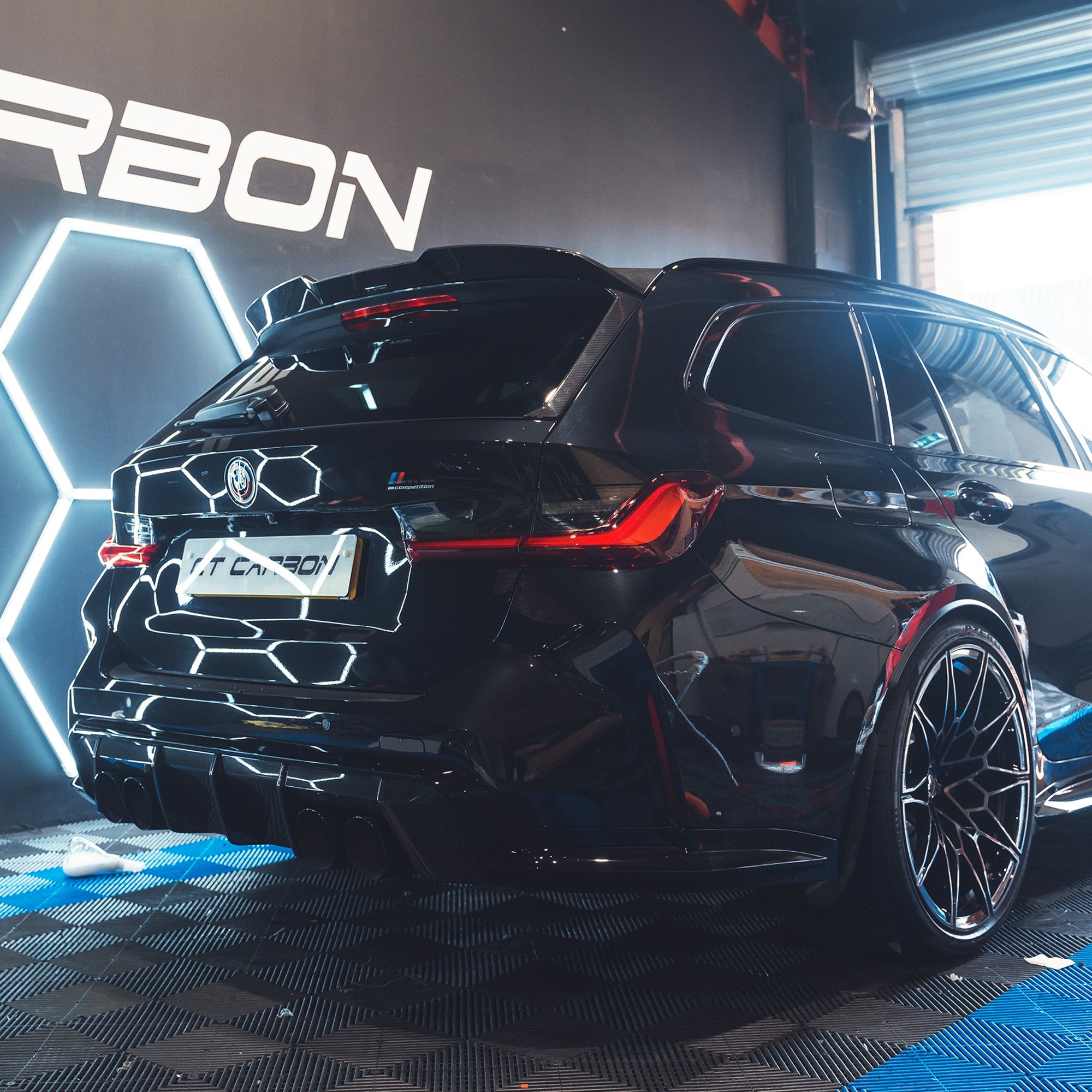 BMW M3 G81 carbon fibre spoiler by CT Carbon, showcasing sleek aerodynamic design on the car's rear.