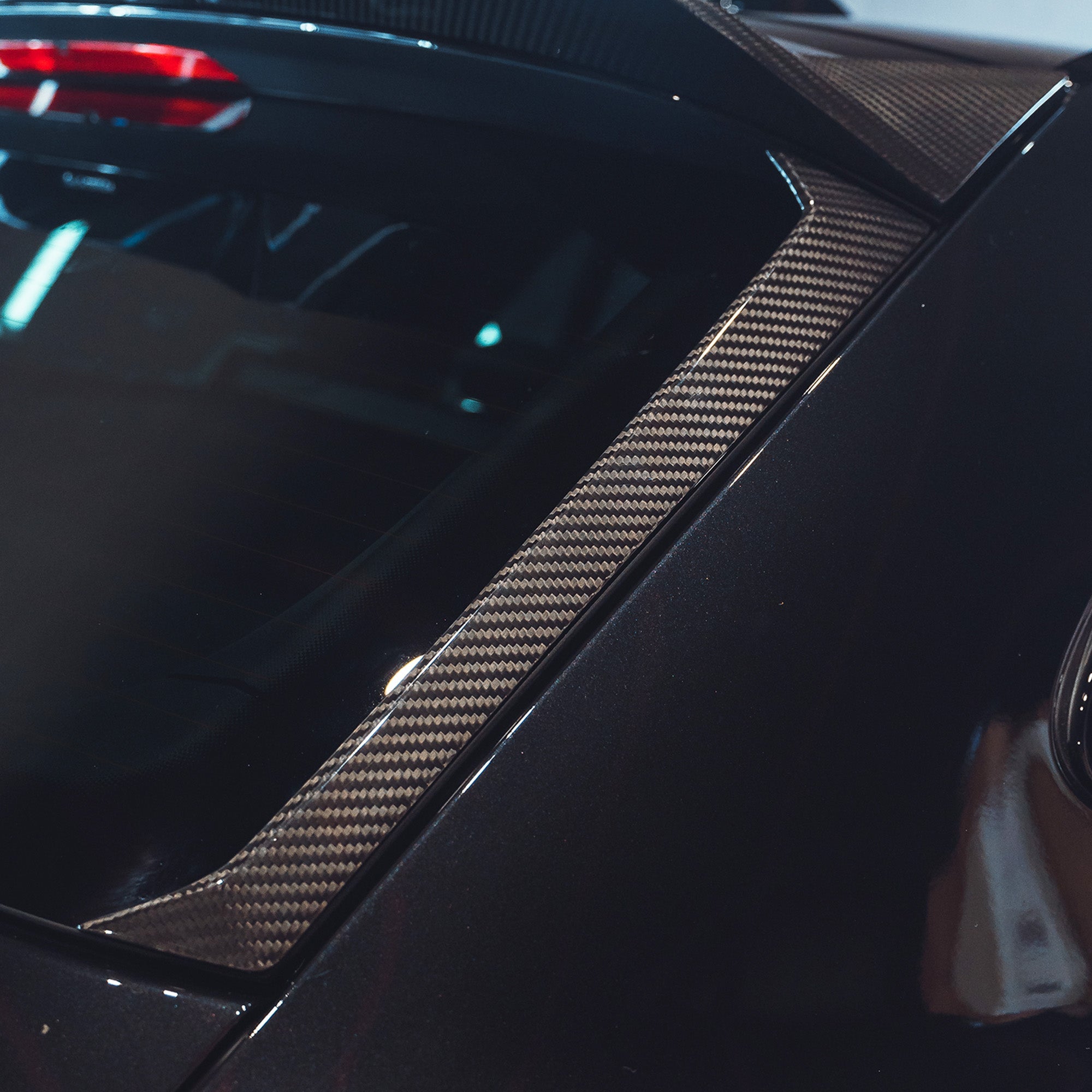 BMW M3 G81 carbon fibre spoiler by CT Carbon, front view showcasing sleek aerodynamic design on the car.