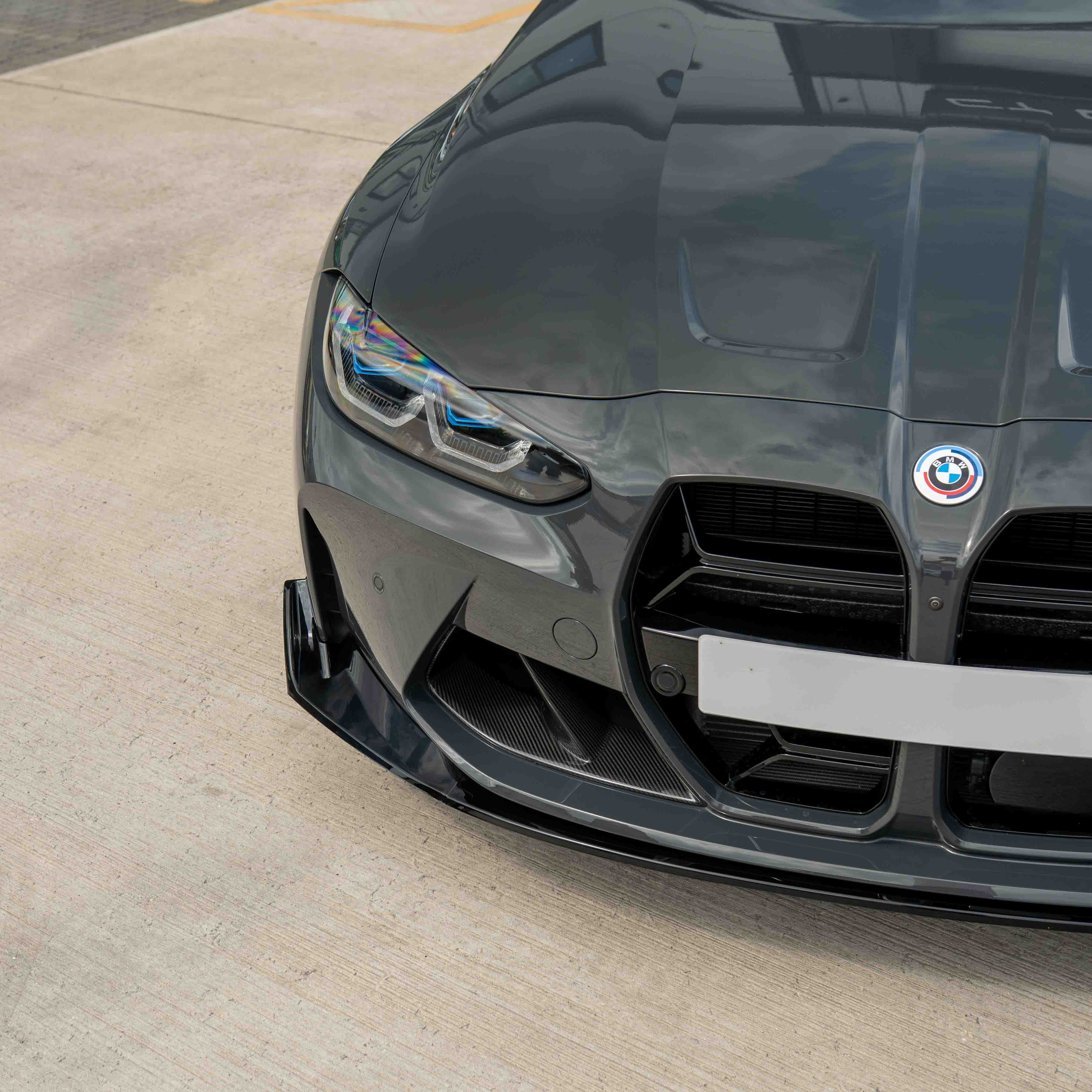 BMW M3 M4 G80 G81 G82 G83 gloss black splitter by CT Carbon, showcasing a sleek, CSL-style aerodynamic front splitter.
