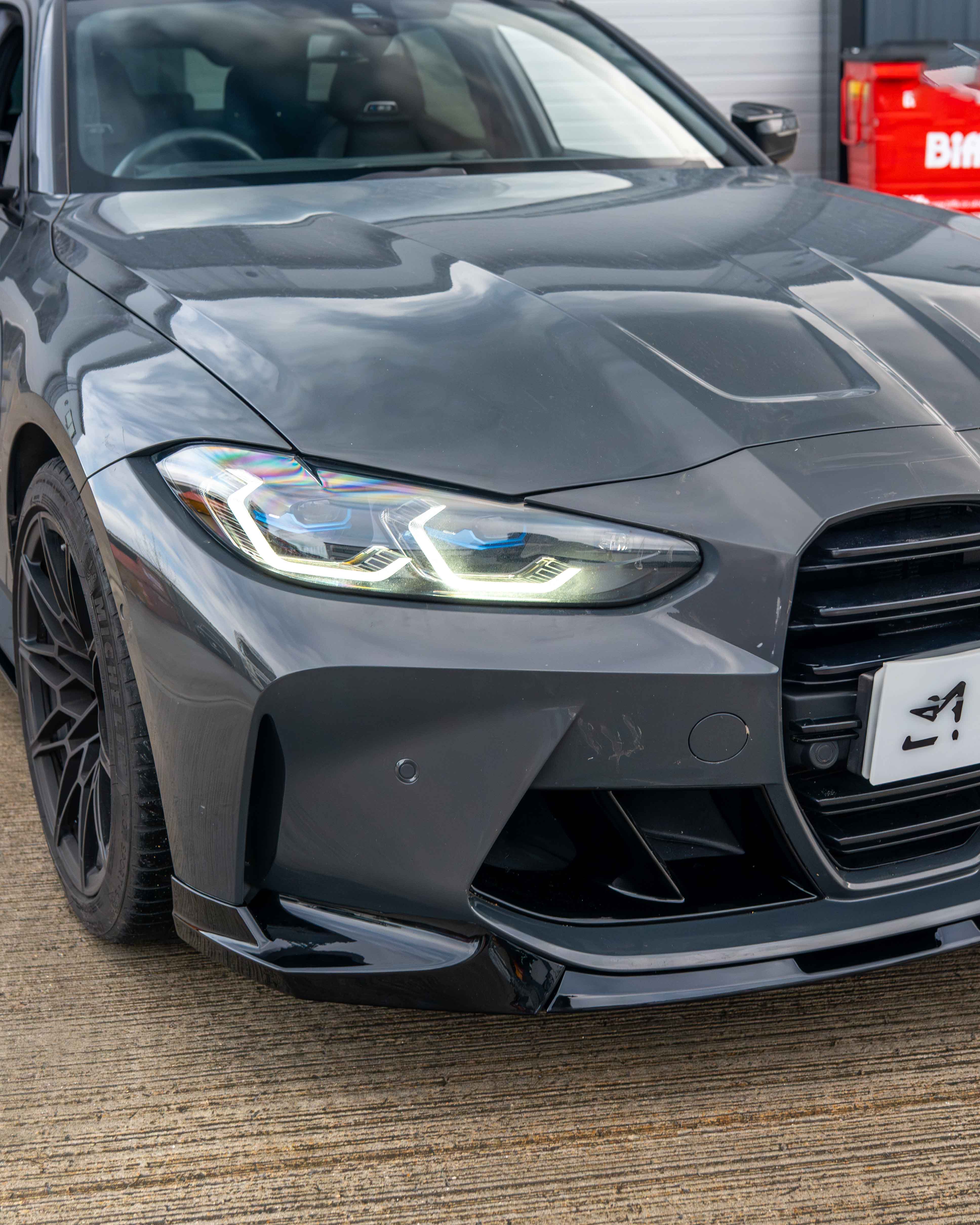 BMW M3 and M4 G80 G81 G82 G83 gloss black splitter by CT Carbon, showcasing the sleek, aerodynamic front splitter design.