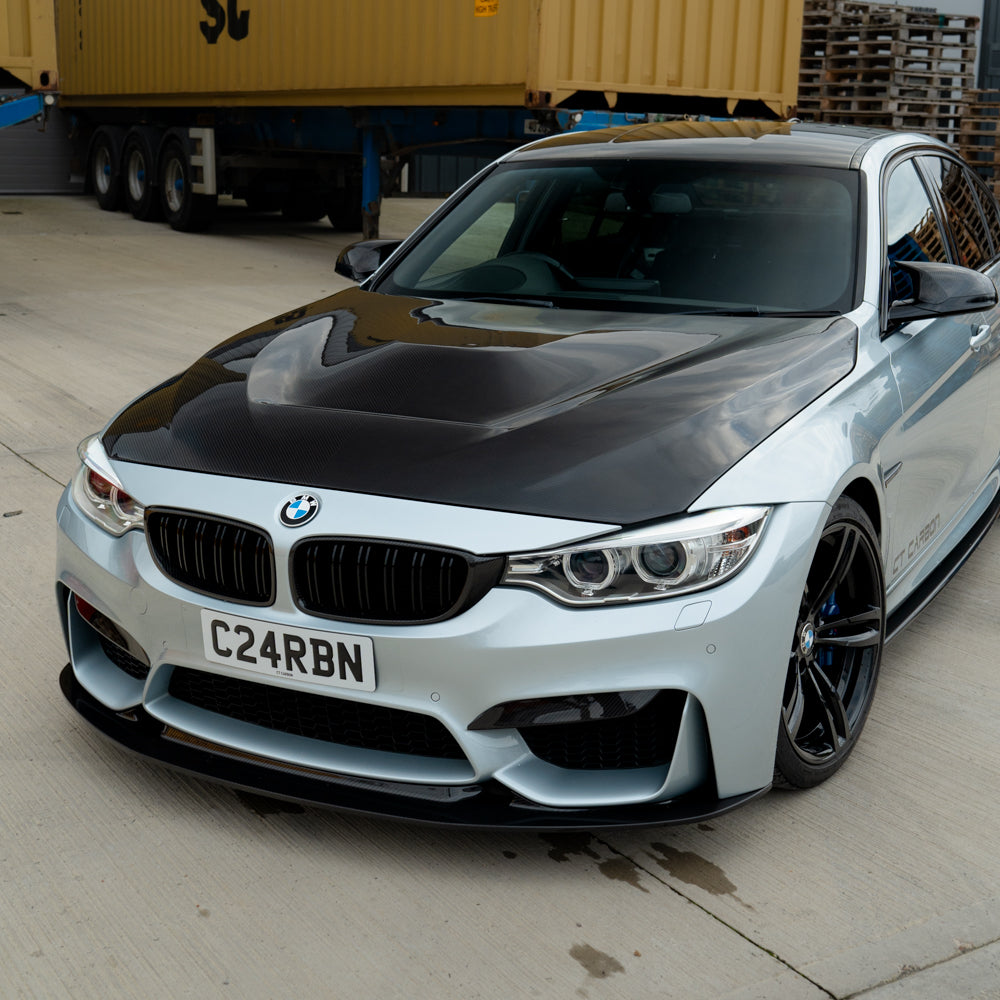 BMW M3 M4 F80 F82 F83 carbon fiber upper front canards by CT Carbon, lightweight aerodynamic car accessories with a sleek finish.