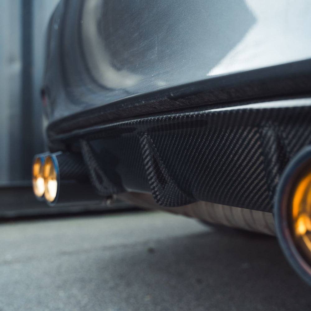 BMW M3 M4 F80 F82 F83 CT Carbon fiber diffuser V1 with sleek carbon fiber finish, designed for high-performance car styling.