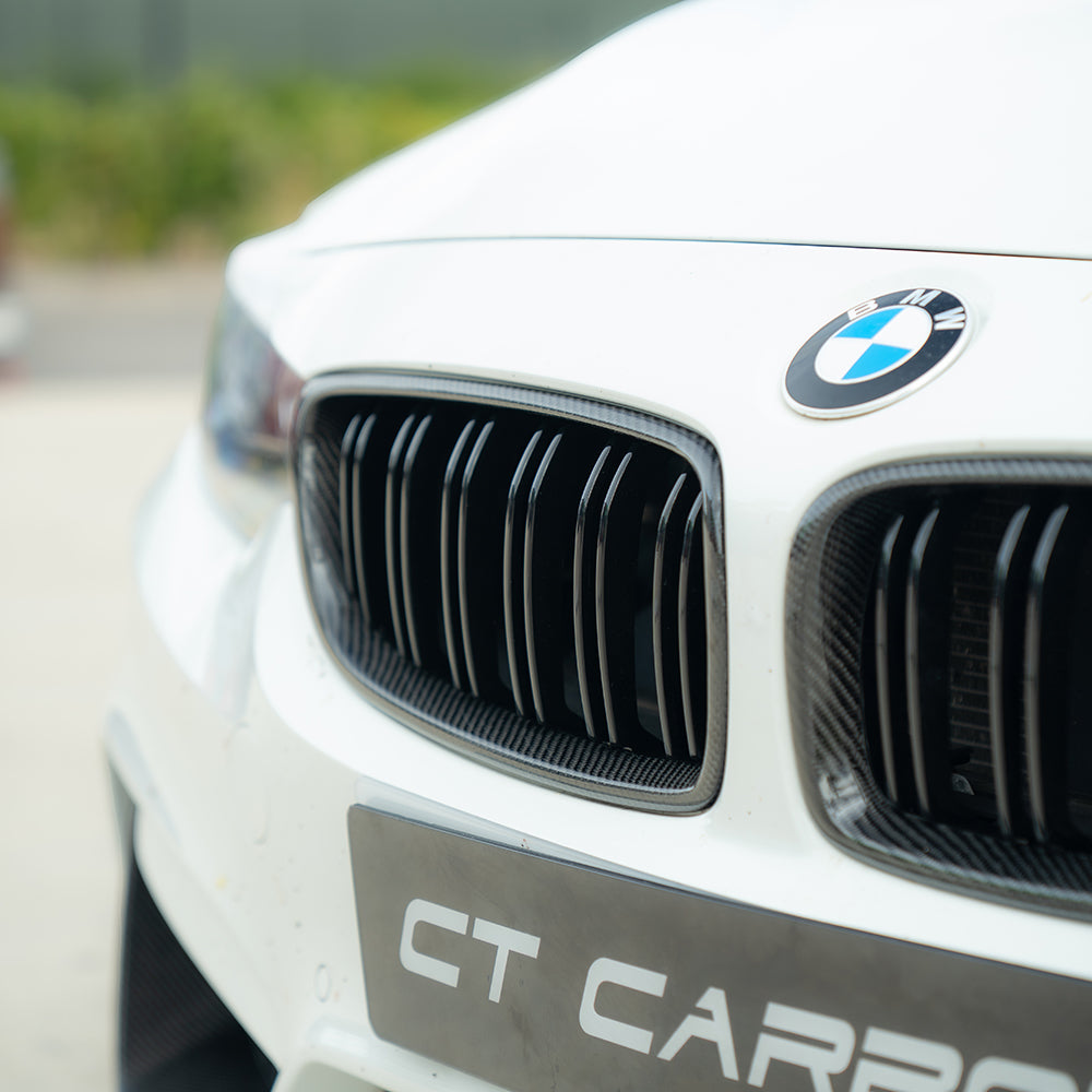 BMW M3 M4 F80 F82 F83 carbon fiber front grille by CT Carbon, showcasing sleek, lightweight design and textured carbon fiber finish.