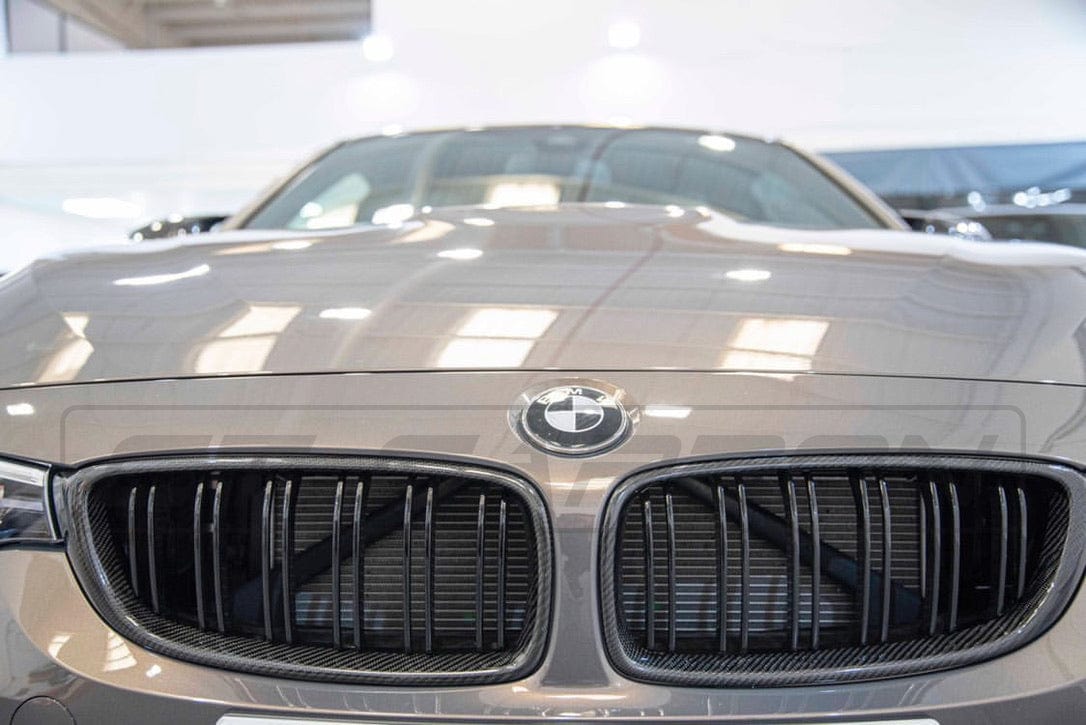 BMW M3 M4 F80 F82 F83 CT Carbon fiber front grille showing sleek, lightweight carbon fiber design on a sporty car model.