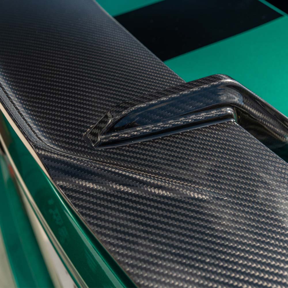 BMW G80 M3 and G82 M4 carbon fibre spoiler by CT Carbon, showcasing sleek MP-style wing on a sporty car.