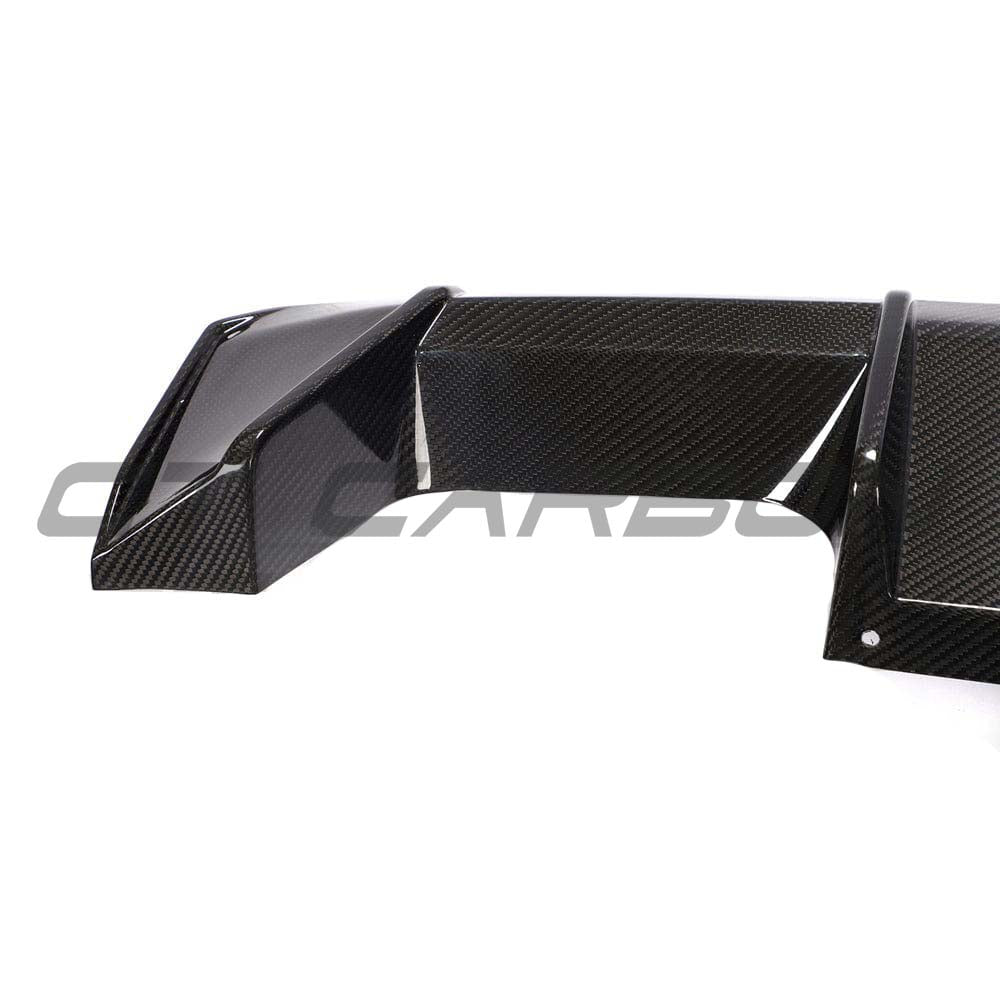 BMW M3 M4 G80 G82 G83 carbon fiber diffuser by CT Carbon, V2 style, showcasing sleek, lightweight carbon fiber design and aerodynamic details.