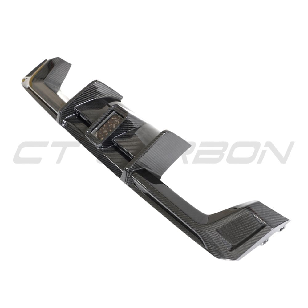 BMW M3 M4 G80 G82 G83 carbon fibre diffuser with LED lights, designed by CT Carbon, showing sleek aerodynamic style.