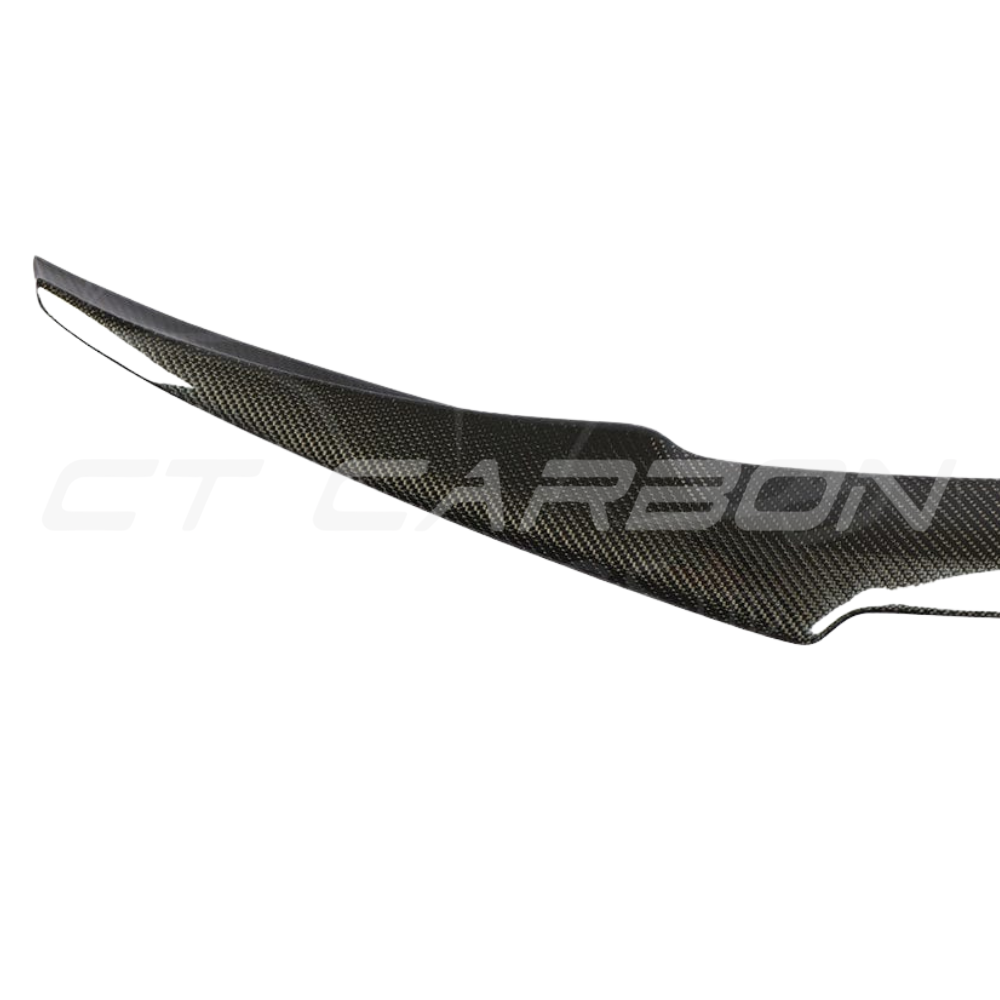 BMW M4 F82 carbon fiber V-style spoiler by CT Carbon, showcasing the sleek, aerodynamic design on the car's rear.