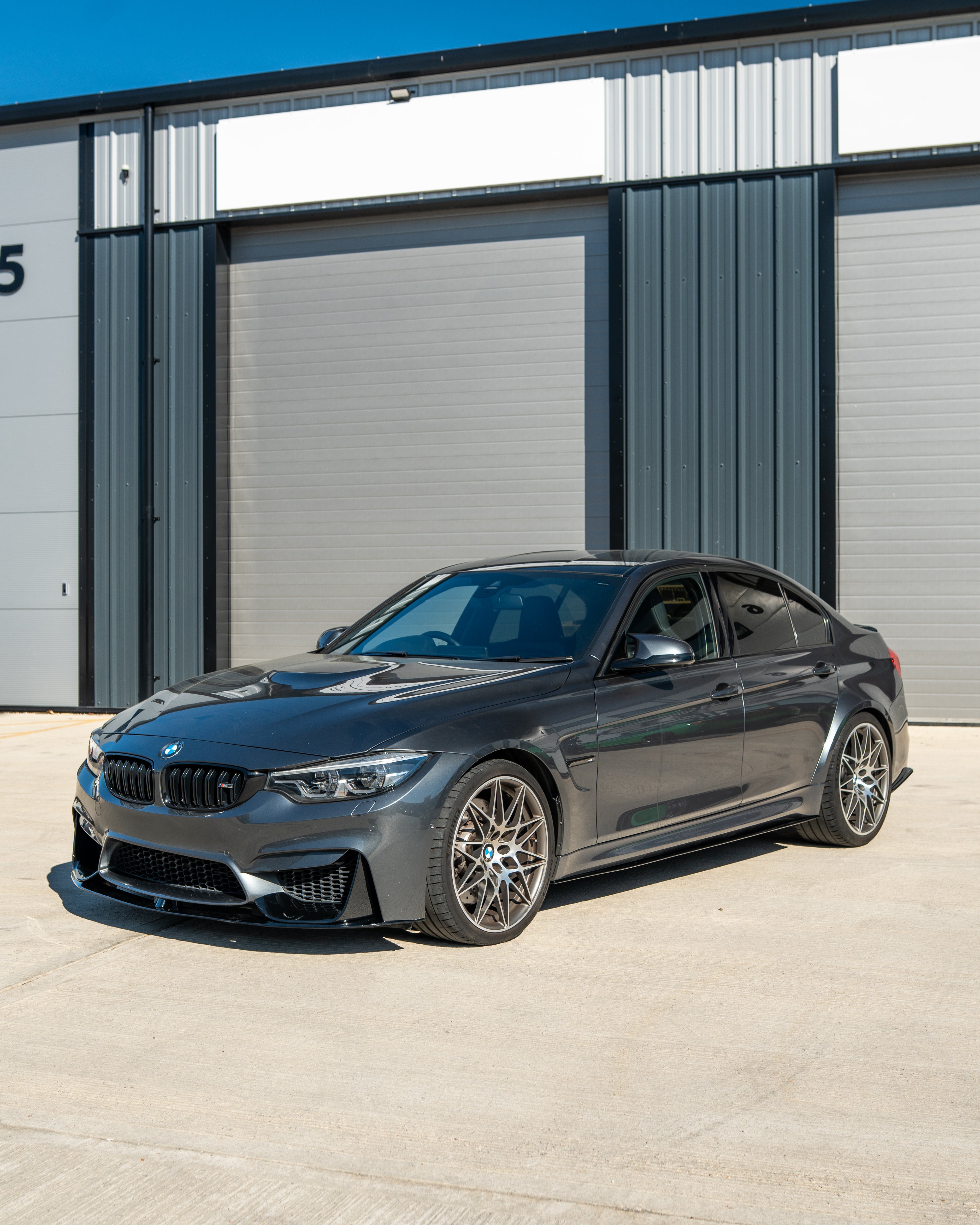 BMW M3 M4 F80 F82 F83 GLOSS BLACK splitter by CT Carbon, shown on a coupe with sleek, aerodynamic design and high-gloss finish.