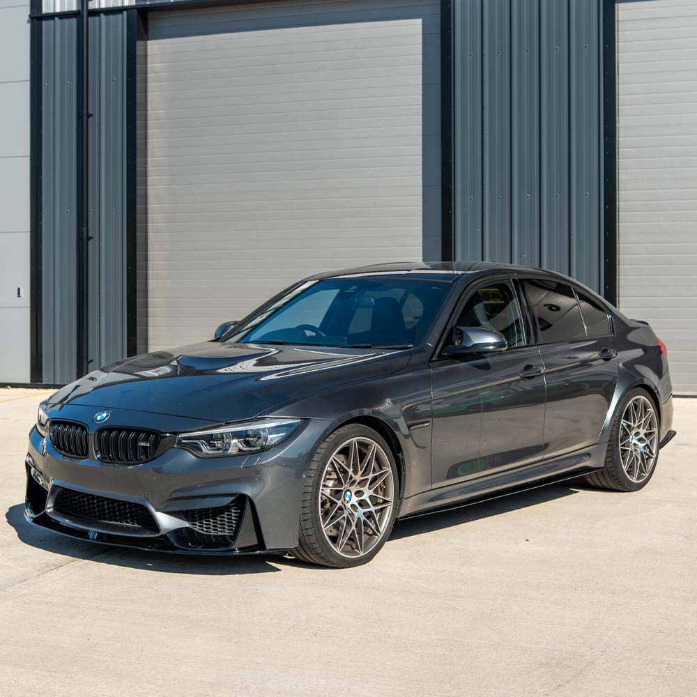 BMW M4 F82 coupe with CT Carbon full gloss black kit, showcasing sleek carbon fiber accents and aerodynamic enhancements.