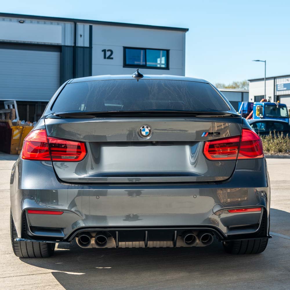 Full gloss black kit for BMW M4 F82 coupe by CT Carbon, showing aerodynamic body kit components on the vehicle.