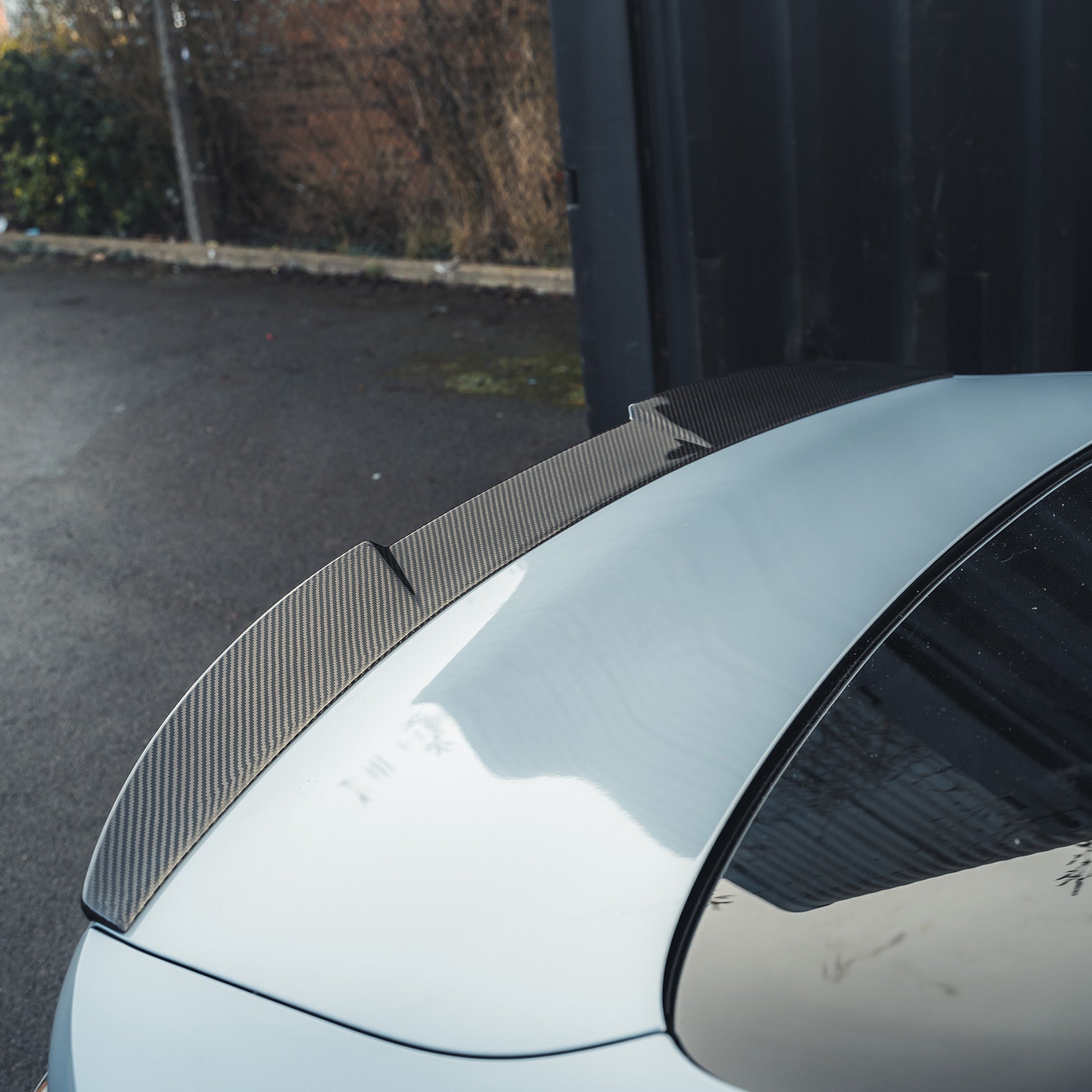BMW M4 G82 and 4 Series G22 carbon fibre spoiler by CT Carbon, showcasing sleek, aerodynamic design on the car's rear.