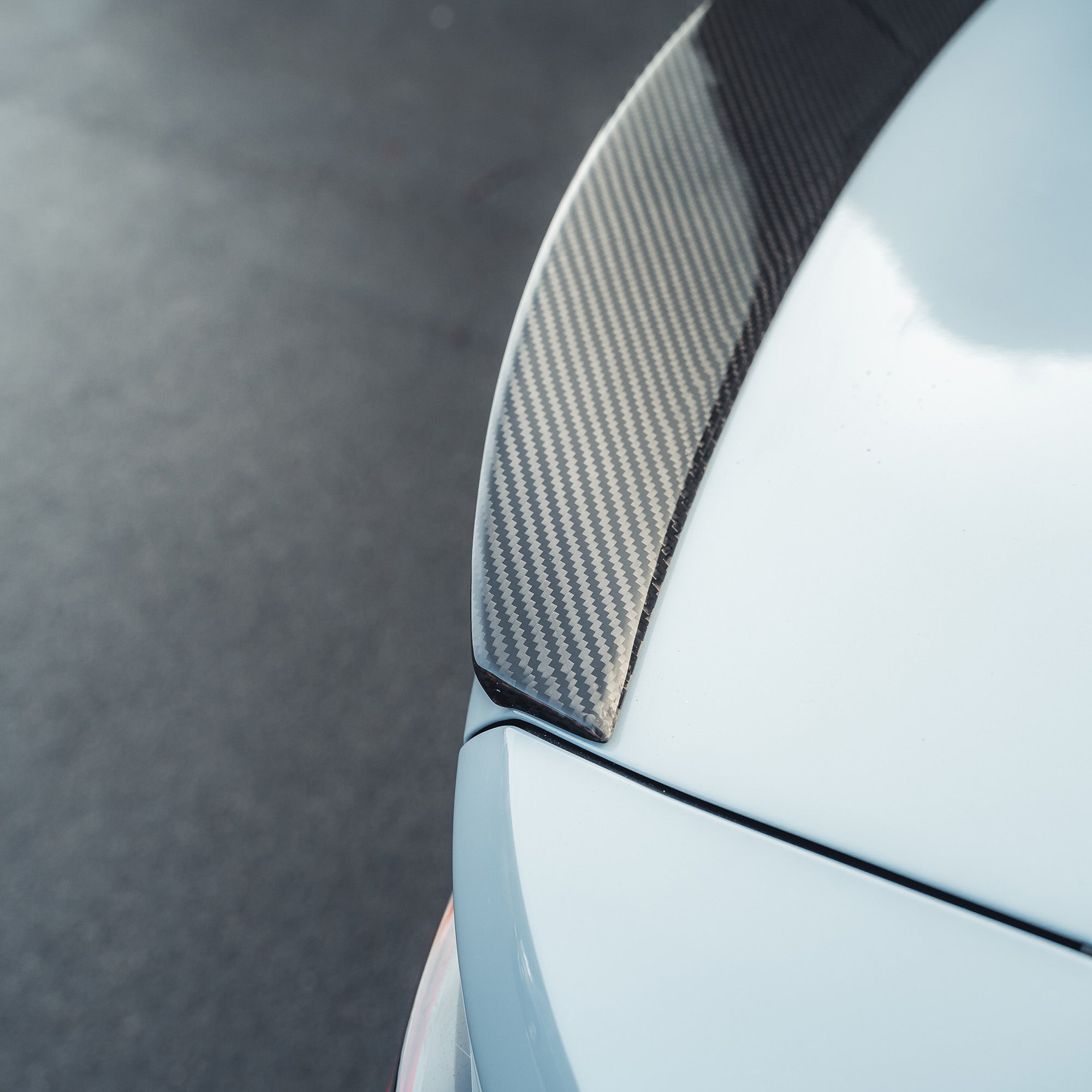BMW M4 G82 and G22 carbon fibre spoiler by CT Carbon, showcasing sleek aerodynamic design with a glossy finish.