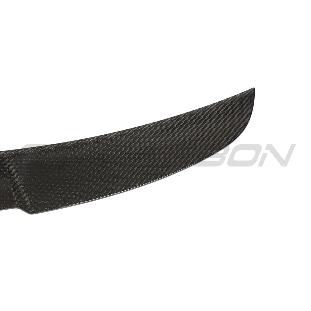 BMW G22 4 Series carbon fiber kit by CT Carbon, including M4-style spoiler visible on this sleek, sporty car upgrade.