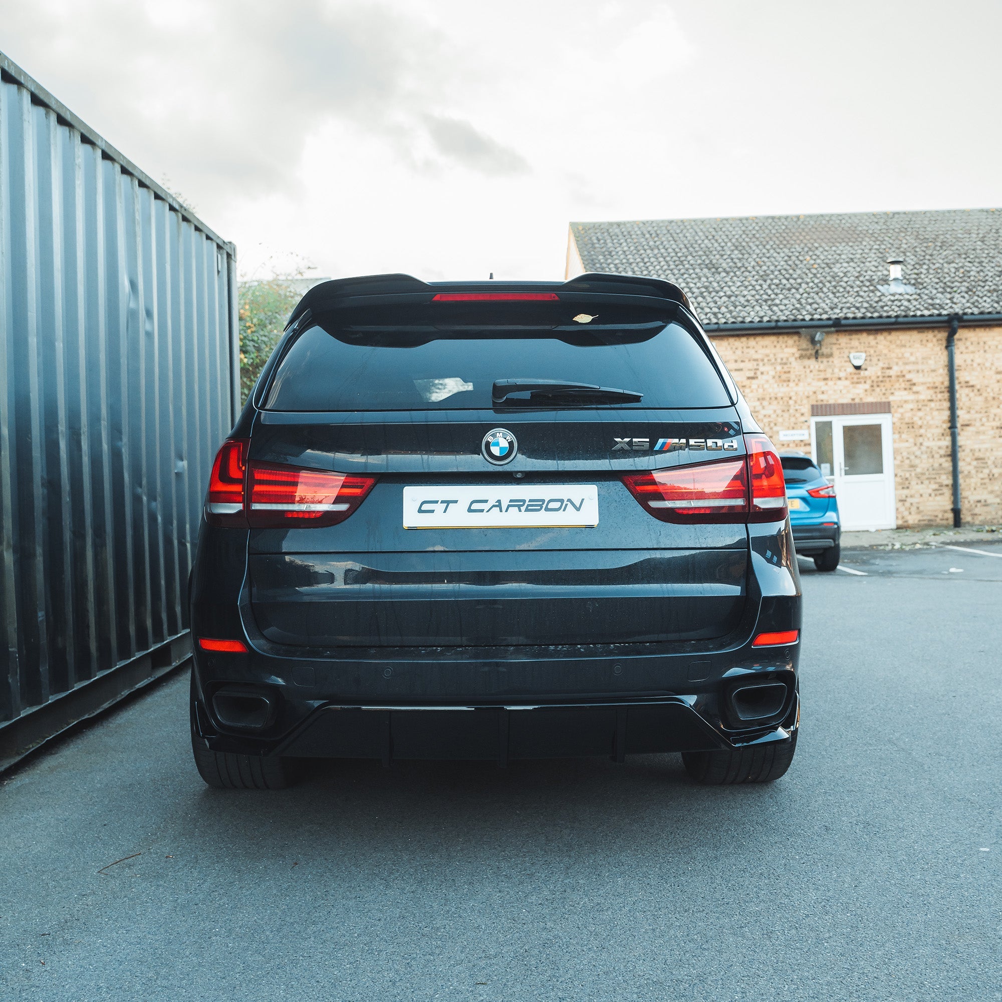 BMW F15 X5 2014-2018 CT Carbon full gloss black kit, including exterior parts, installed on vehicle for a sleek, stylish look.