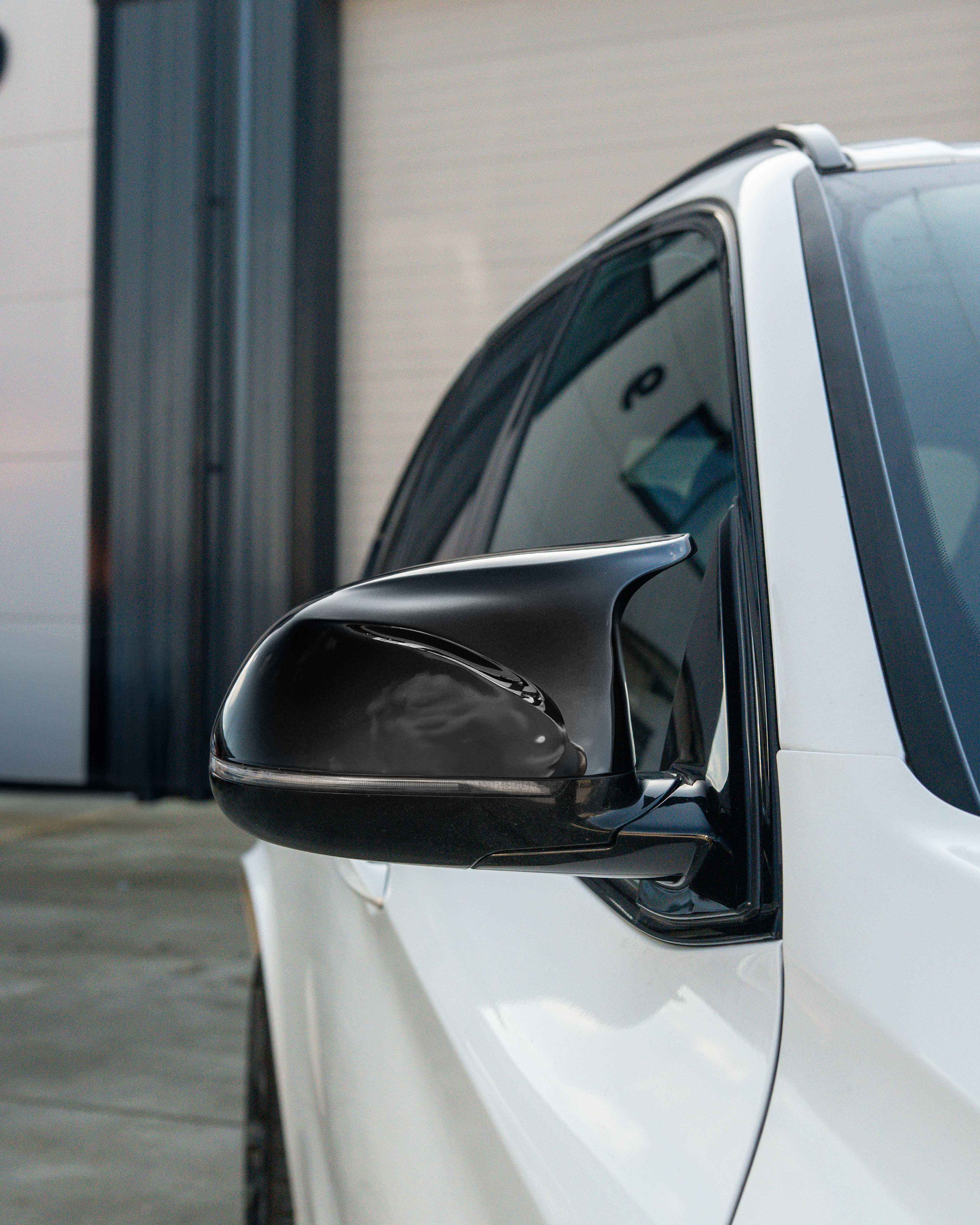 Gloss black BMW F15/F16 X5/X6 mirrors from CT Carbon, automotive accessories for 2014-2018 models, shown on vehicle.