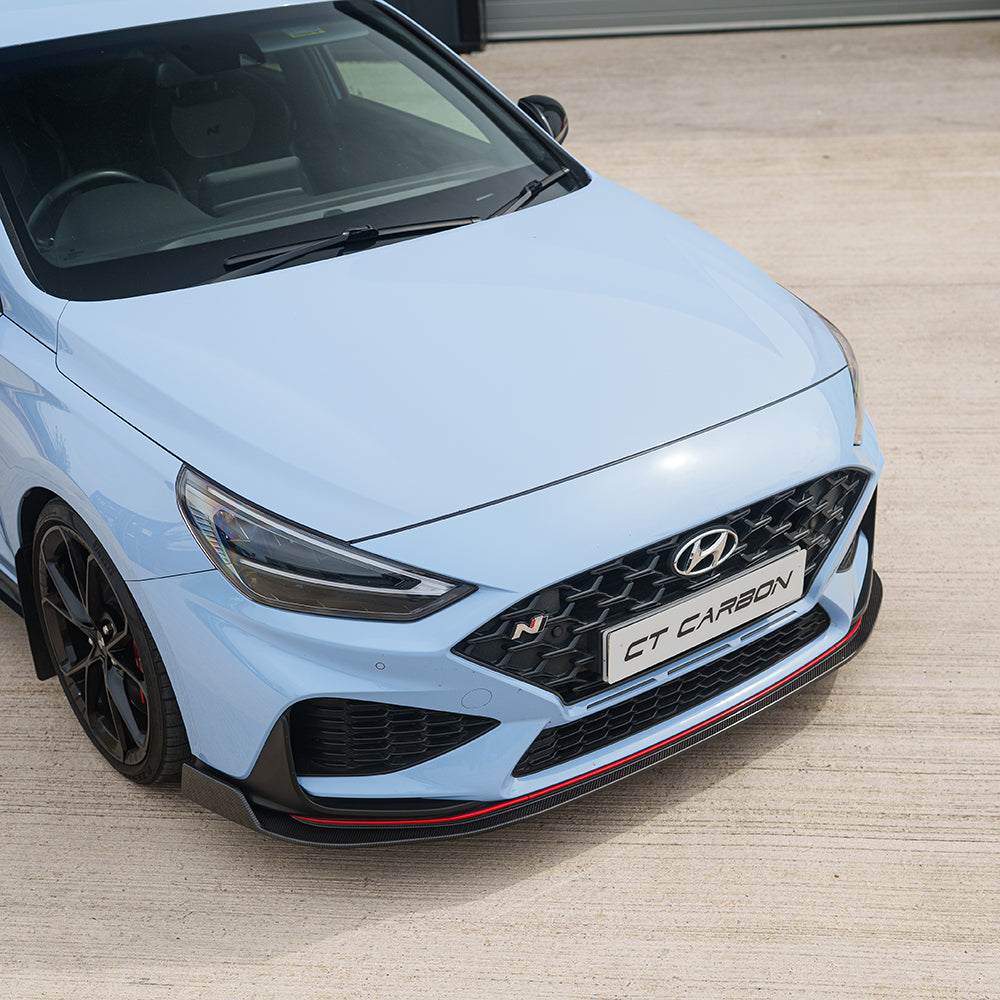 Hyundai i30N front carbon fibre splitter by CT Carbon, showing the sleek, aerodynamic design on a facelift model.