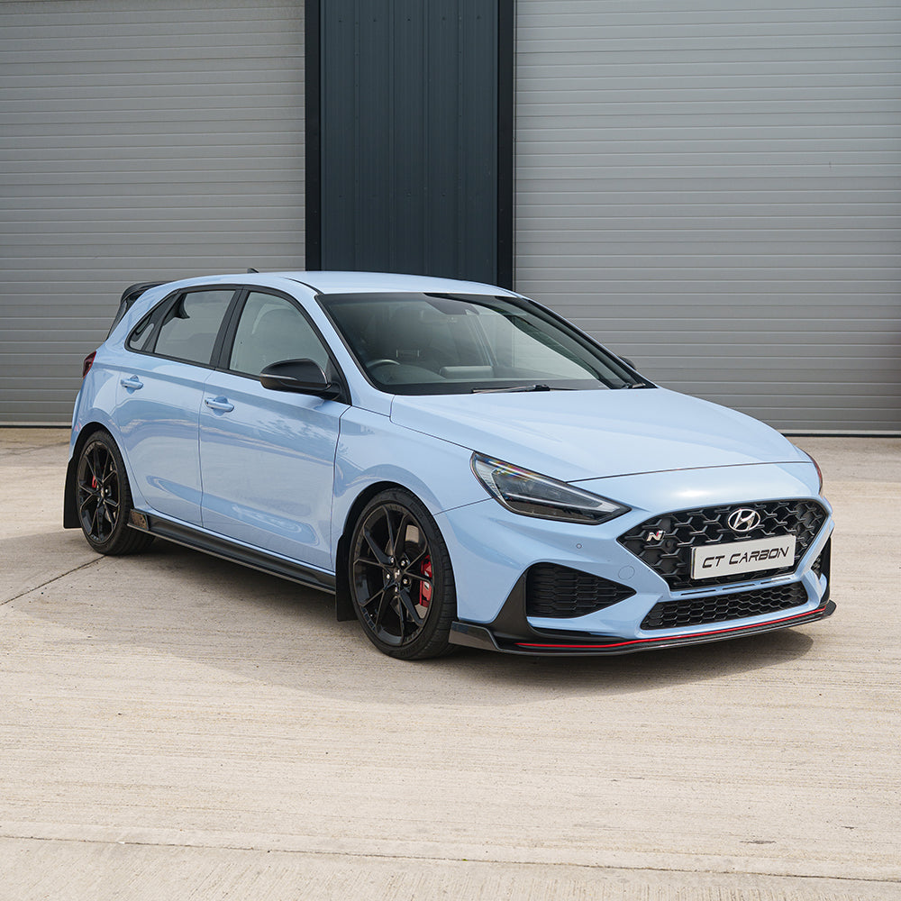 Hyundai i30N side skirts by CT Carbon with carbon fiber finish, designed to enhance the car's sporty exterior.