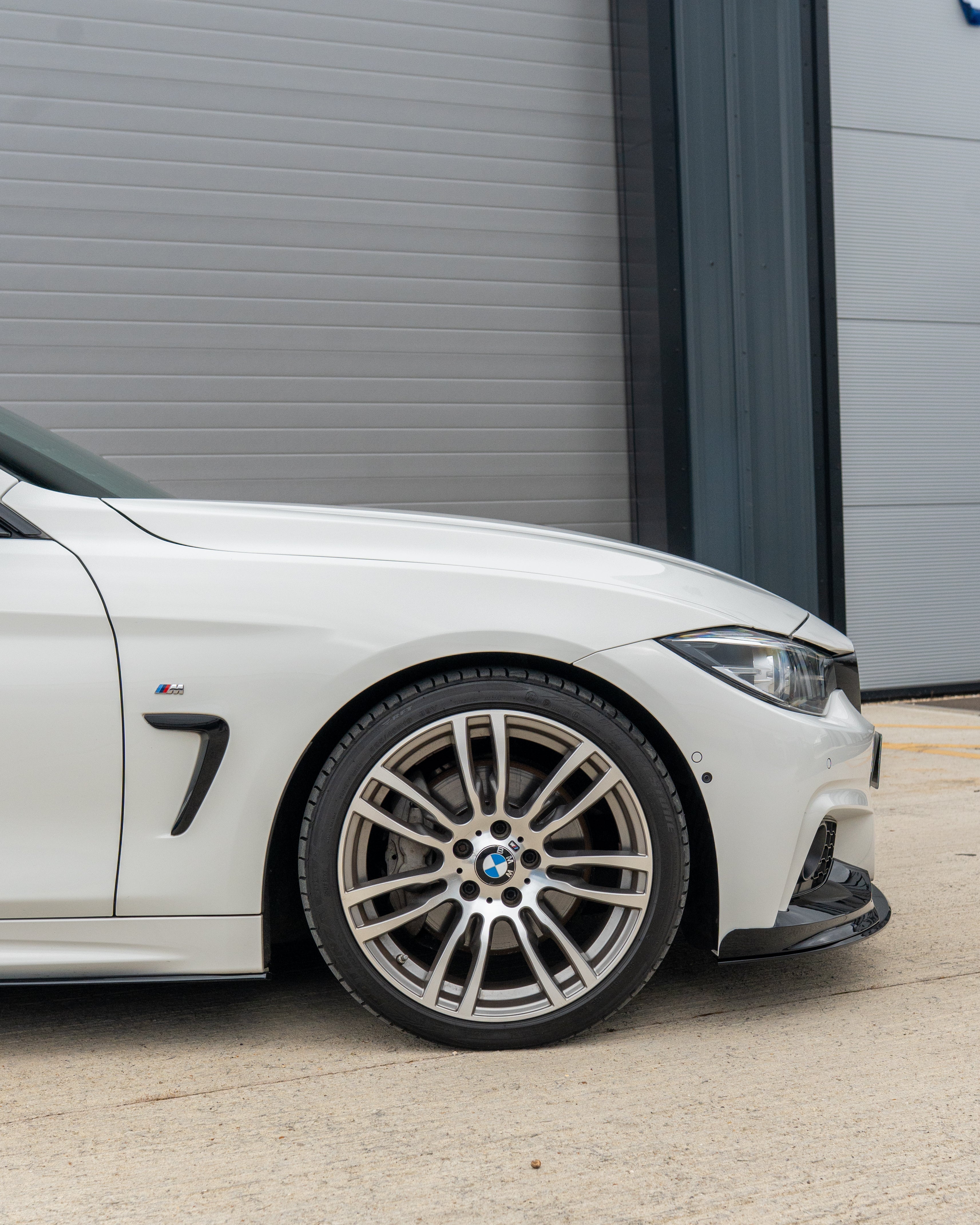 BMW 4 Series F32/F33/F36 CT Carbon gloss black splitter installed on front bumper, showcasing sleek aerodynamic design.