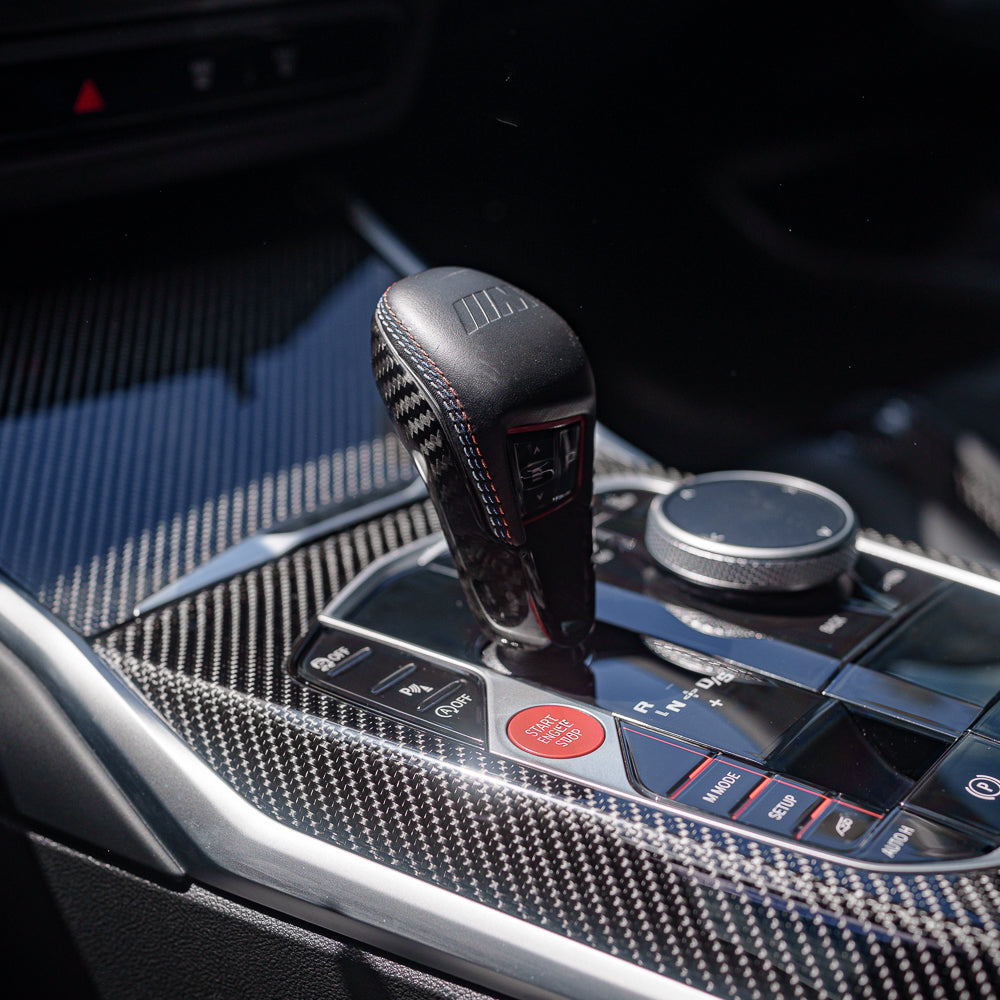 BMW G80 G82 G87 M2 M3 M4 2021+ CT Carbon gear selector cover, sleek black carbon fiber accessory for interior upgrade.