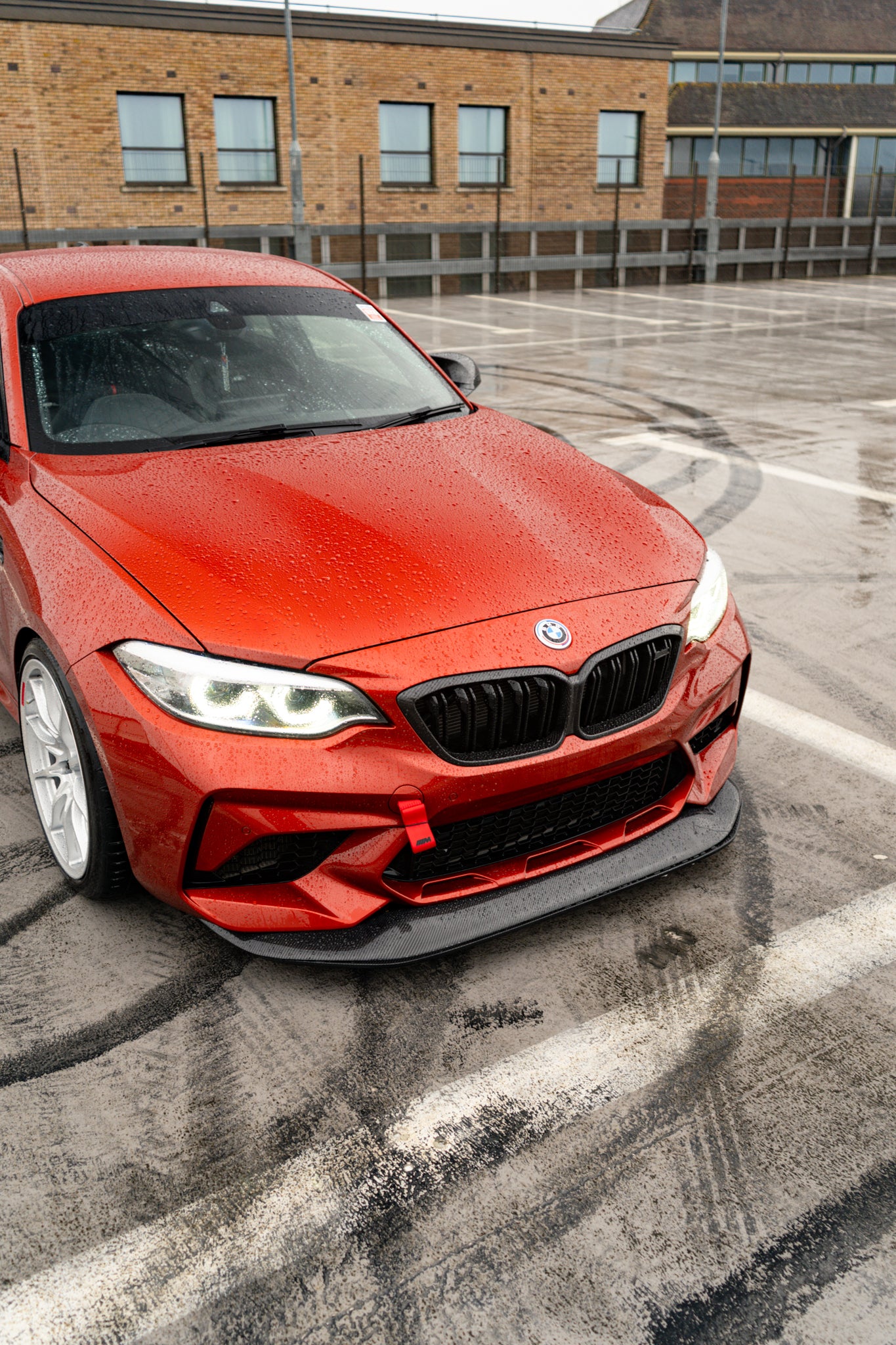 Ridgeline Motorsport F87 M2 Competition carbon fibre GTS front splitter mounted on a BMW M2 Competition for aerodynamic enhancement.