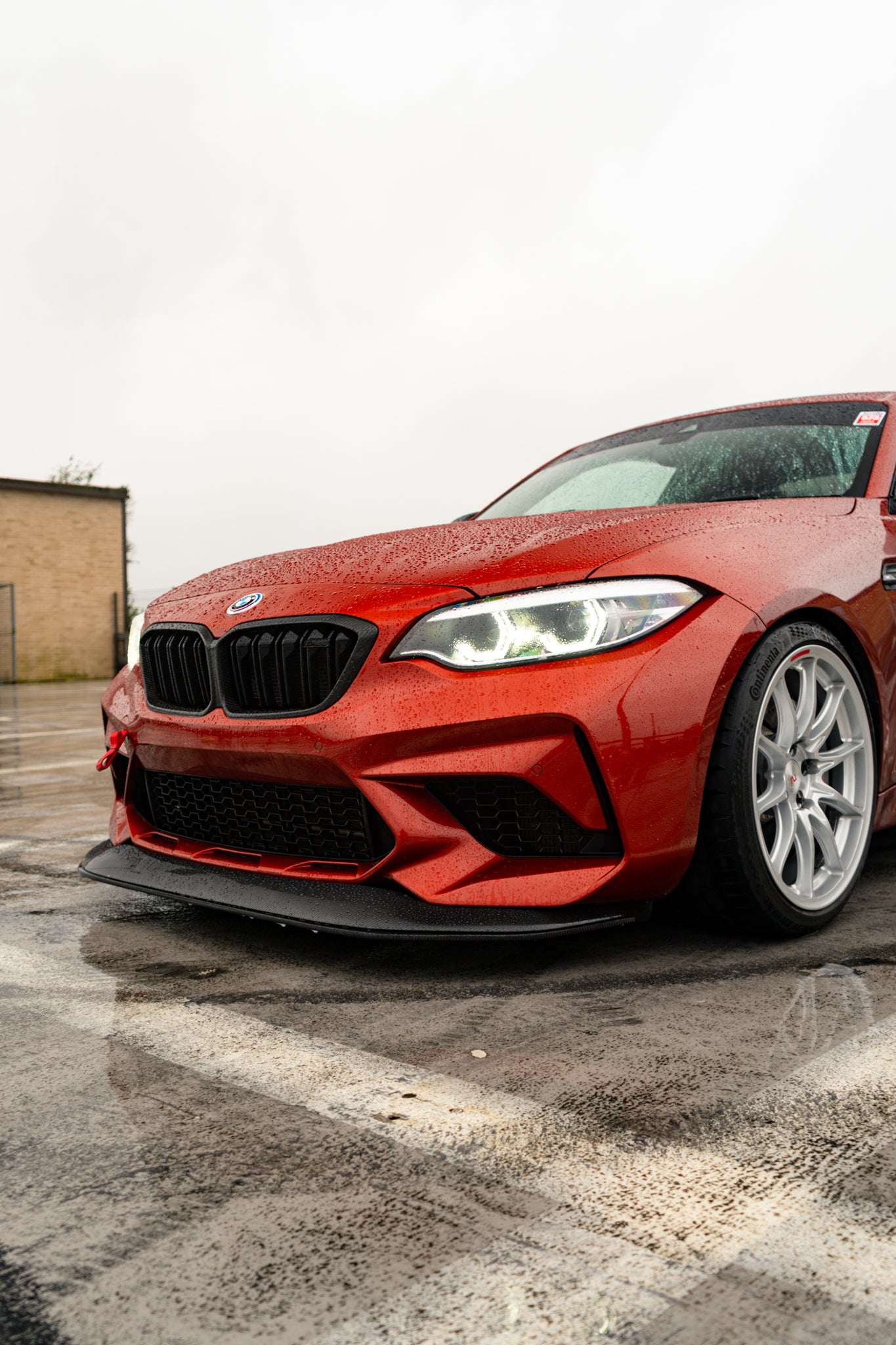 Ridgeline Motorsport F87 M2 Competition carbon fibre GTS front splitter installed on a BMW M2, showcasing aerodynamic design and finish.