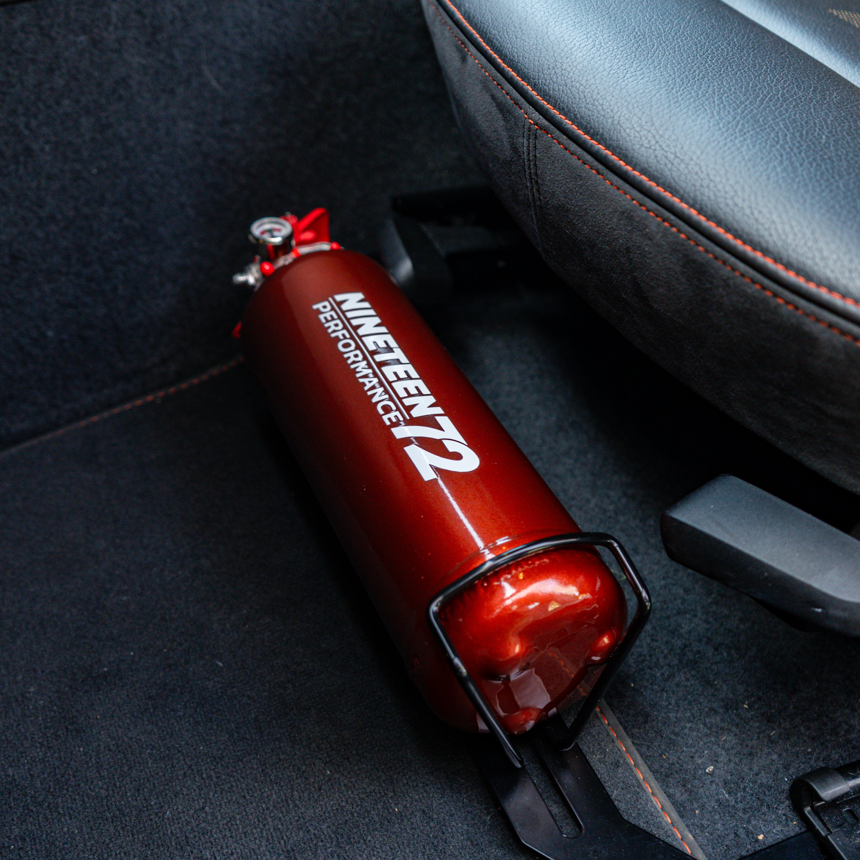 BMW F8X fire extinguisher kit by Race Safe, showing compact fire extinguishers designed for vehicle footwell installation.