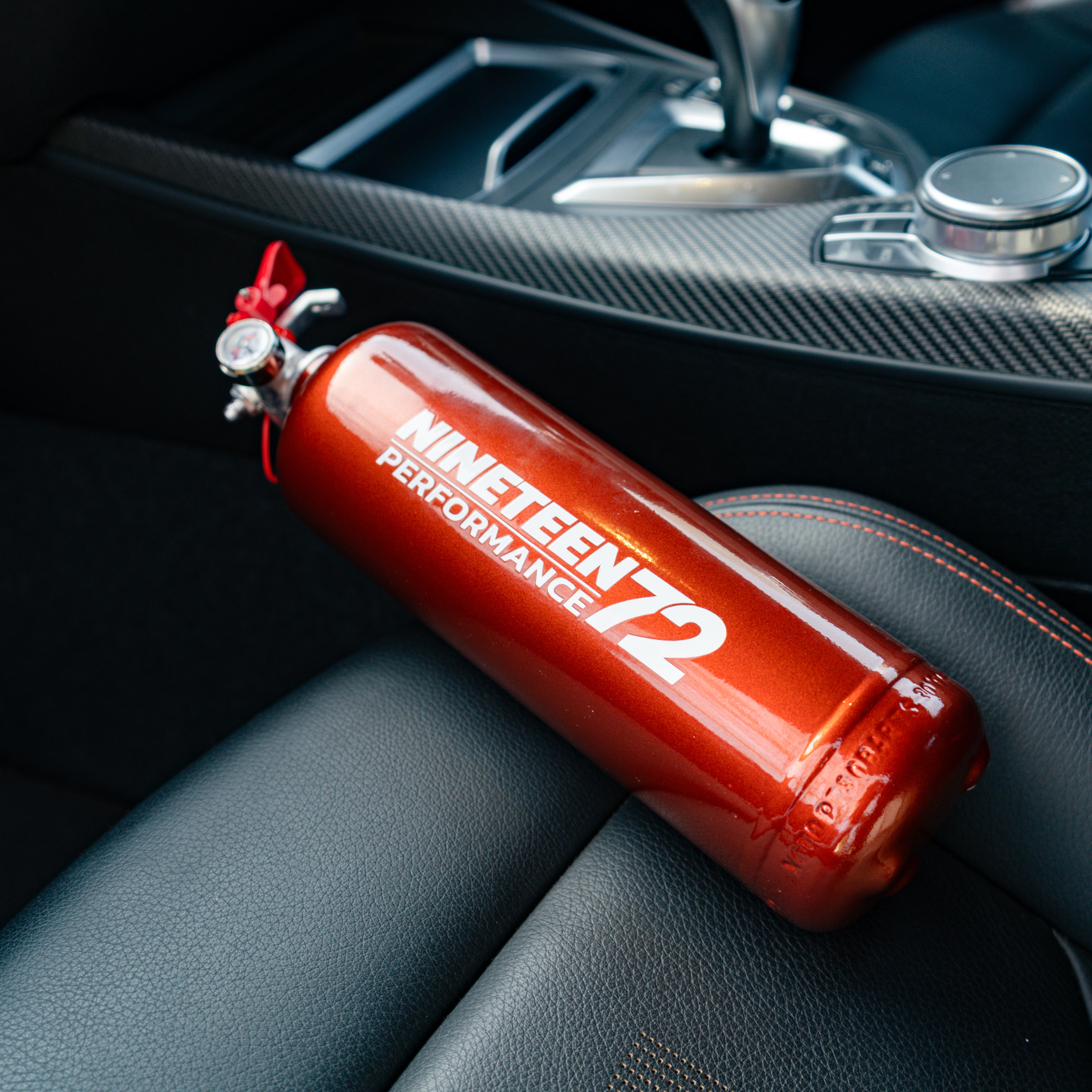 Race Safe BMW F8X footwell fire extinguisher kit with compact fire extinguishers installed in the footwell area.