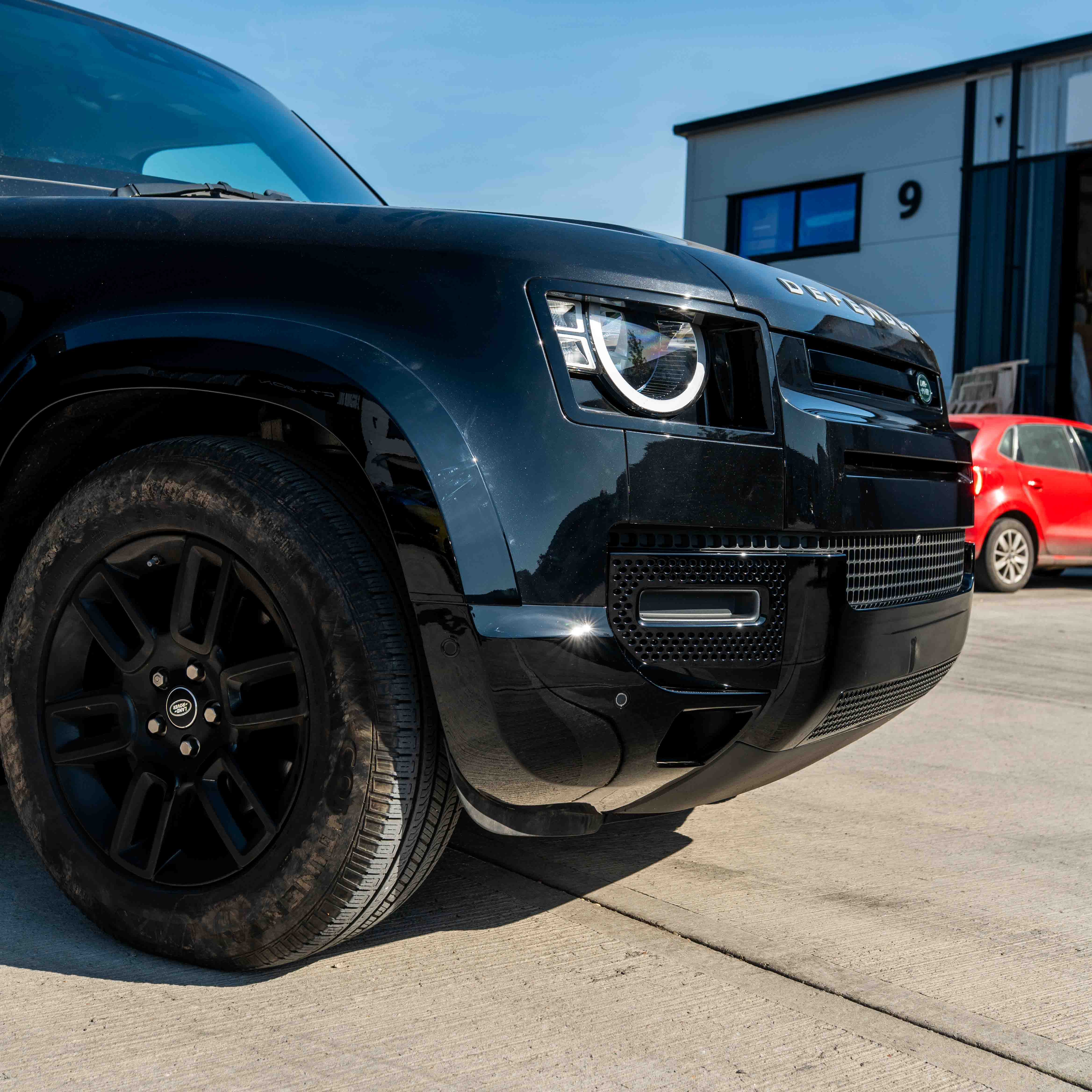 CT Carbon Land Rover Defender L663 110 & 90 gloss black front and rear middle trim kit showing close-up of trim pieces.