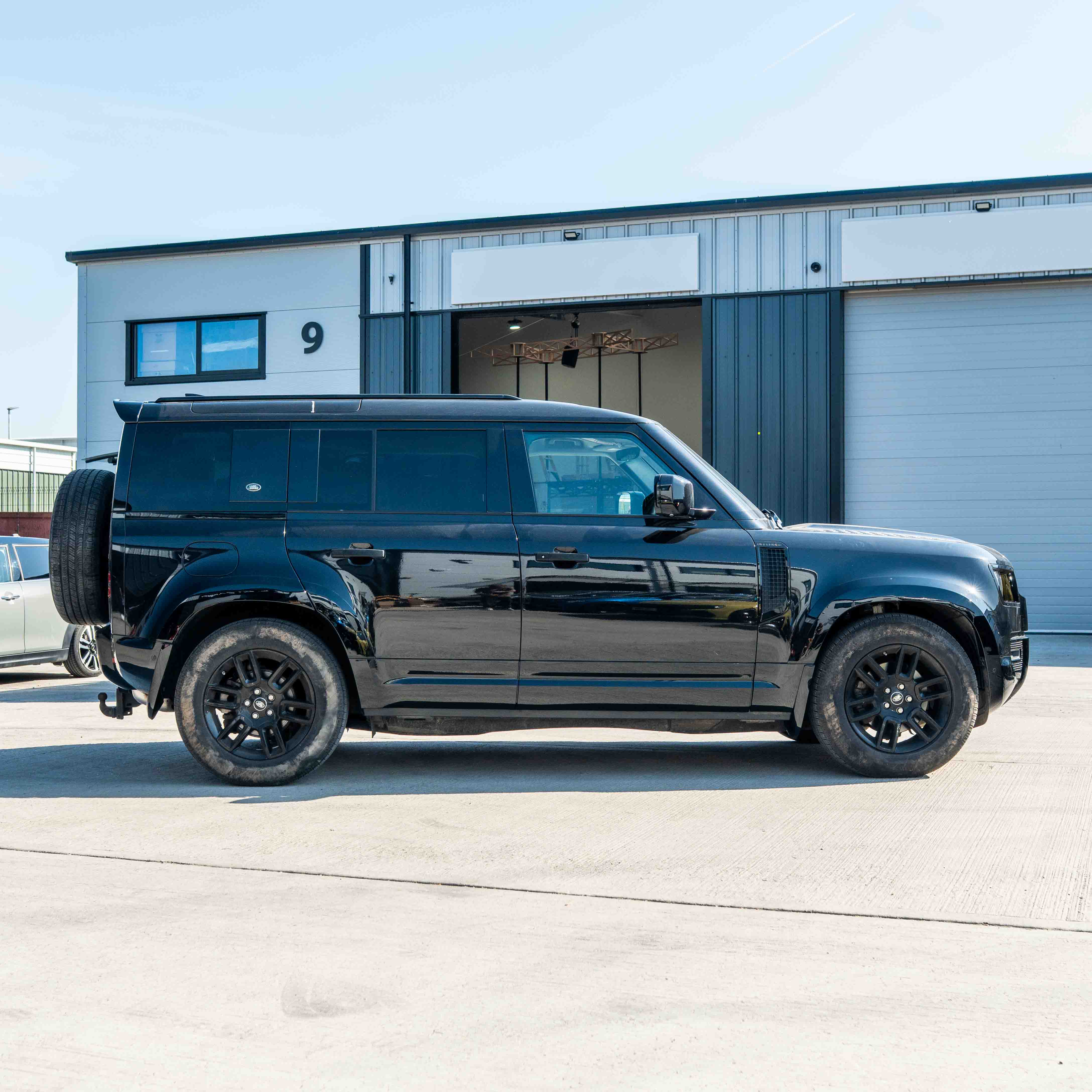 CT Carbon Land Rover Defender L663 110 & 90 gloss black front and rear middle trim kit, for enhanced vehicle interior styling.