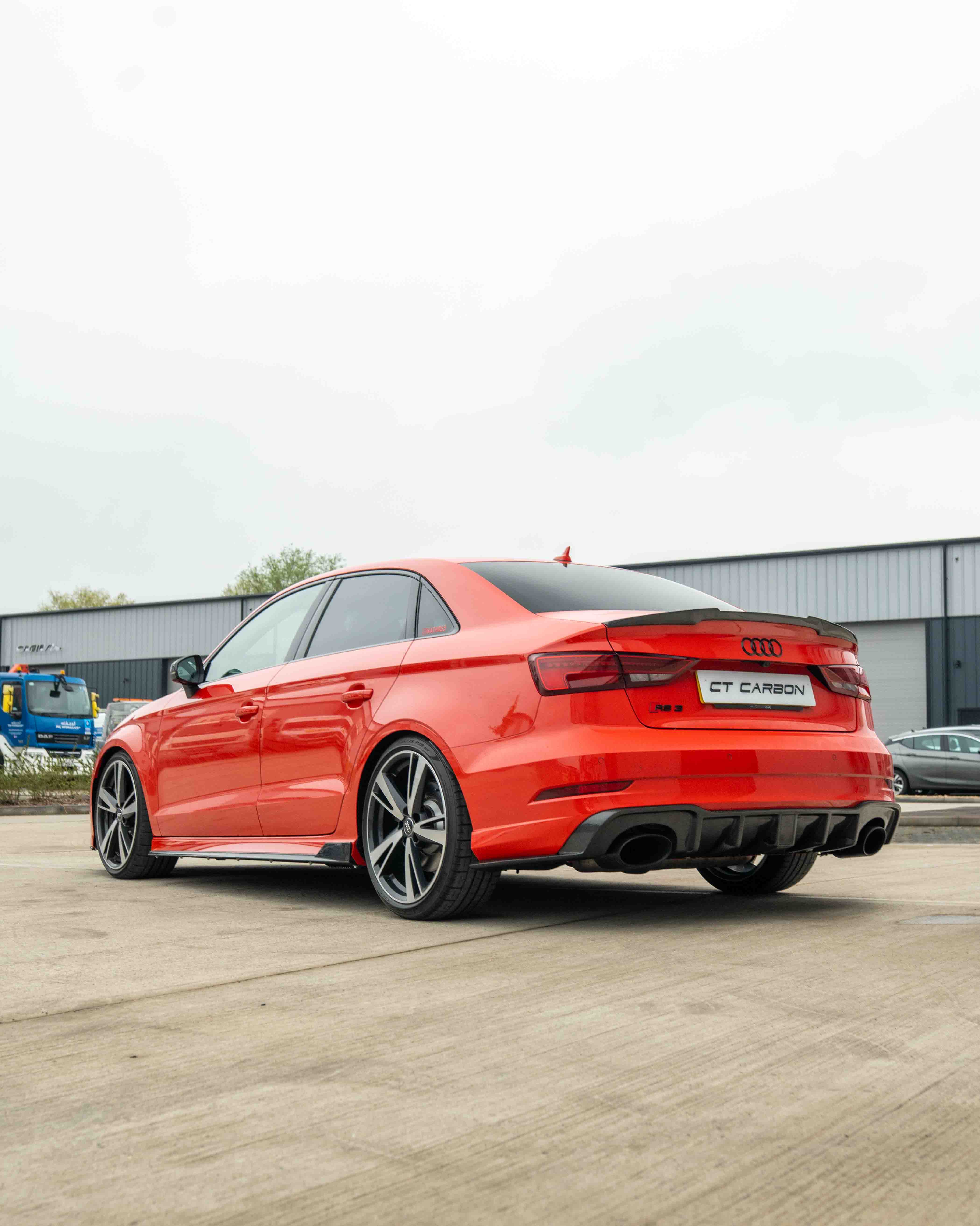 CT Carbon Audi A3 S3 RS3 8V saloon carbon fibre spoiler on car's rear, showcasing sleek aerodynamic design.