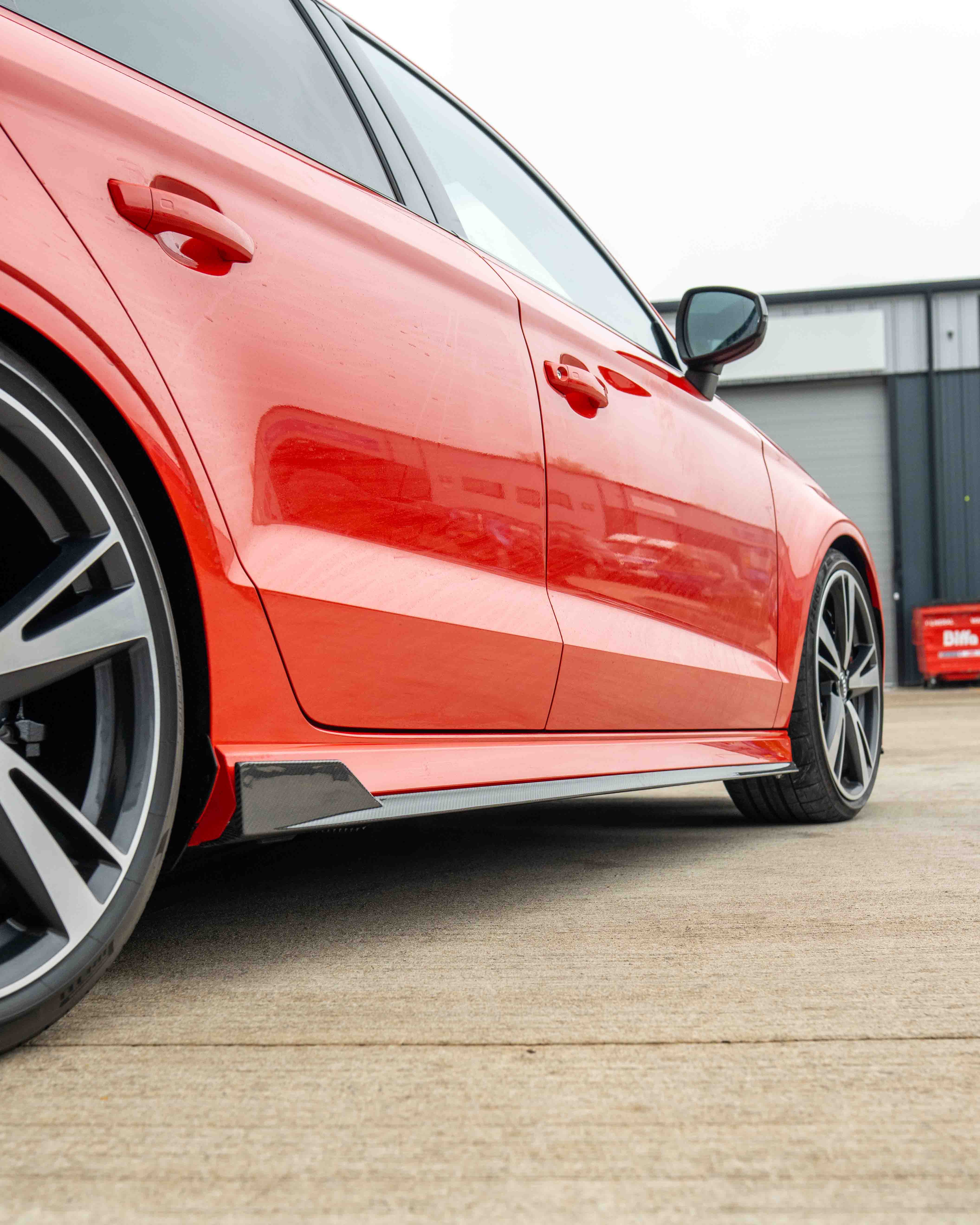 CT Carbon carbon fibre side skirts for Audi A3/S3/RS3 8V saloon car, showcasing sleek, aerodynamic design and high-quality finish.
