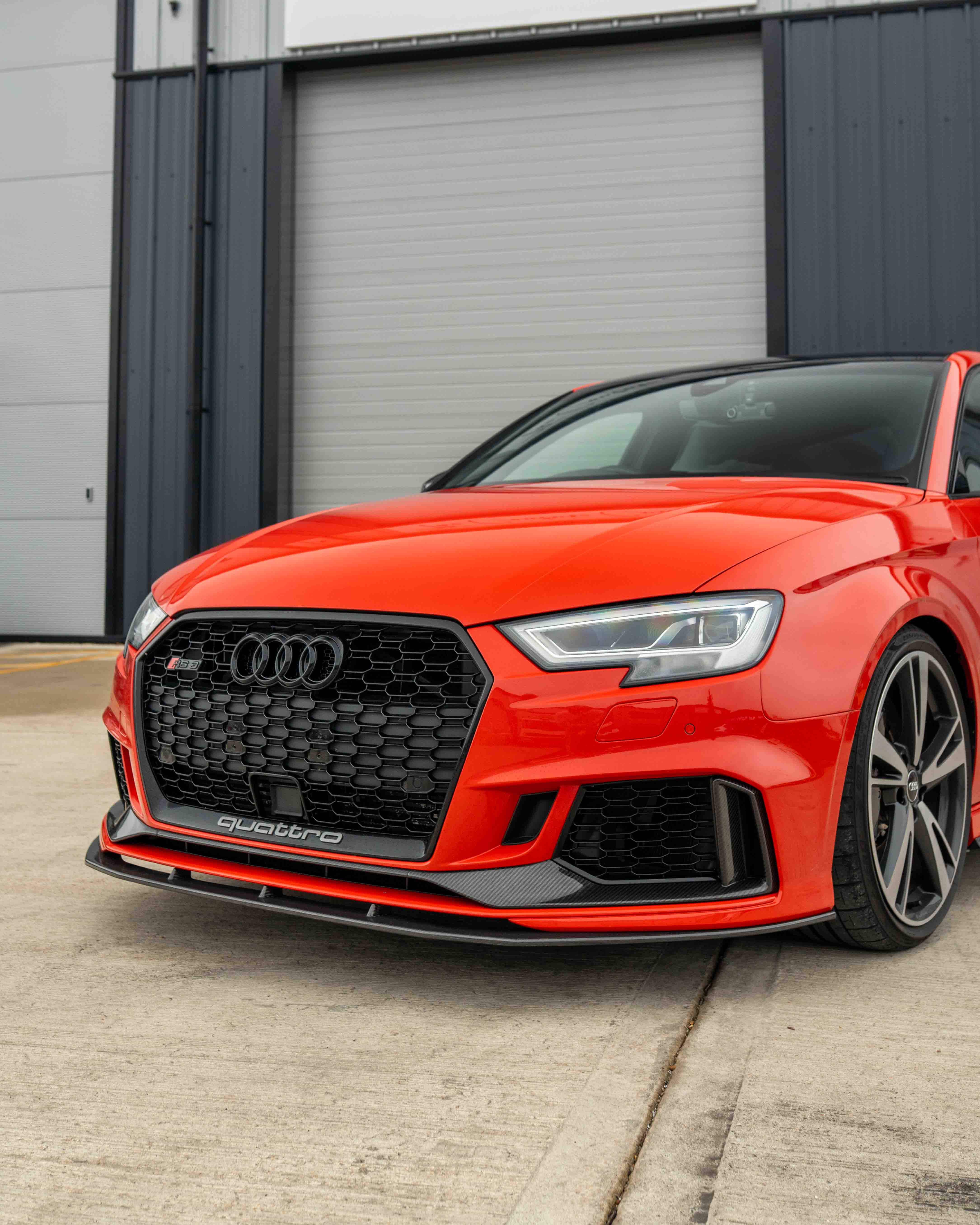 CT Carbon Audi RS3 8V saloon carbon fiber splitter V1, front view showing sleek aerodynamic design.