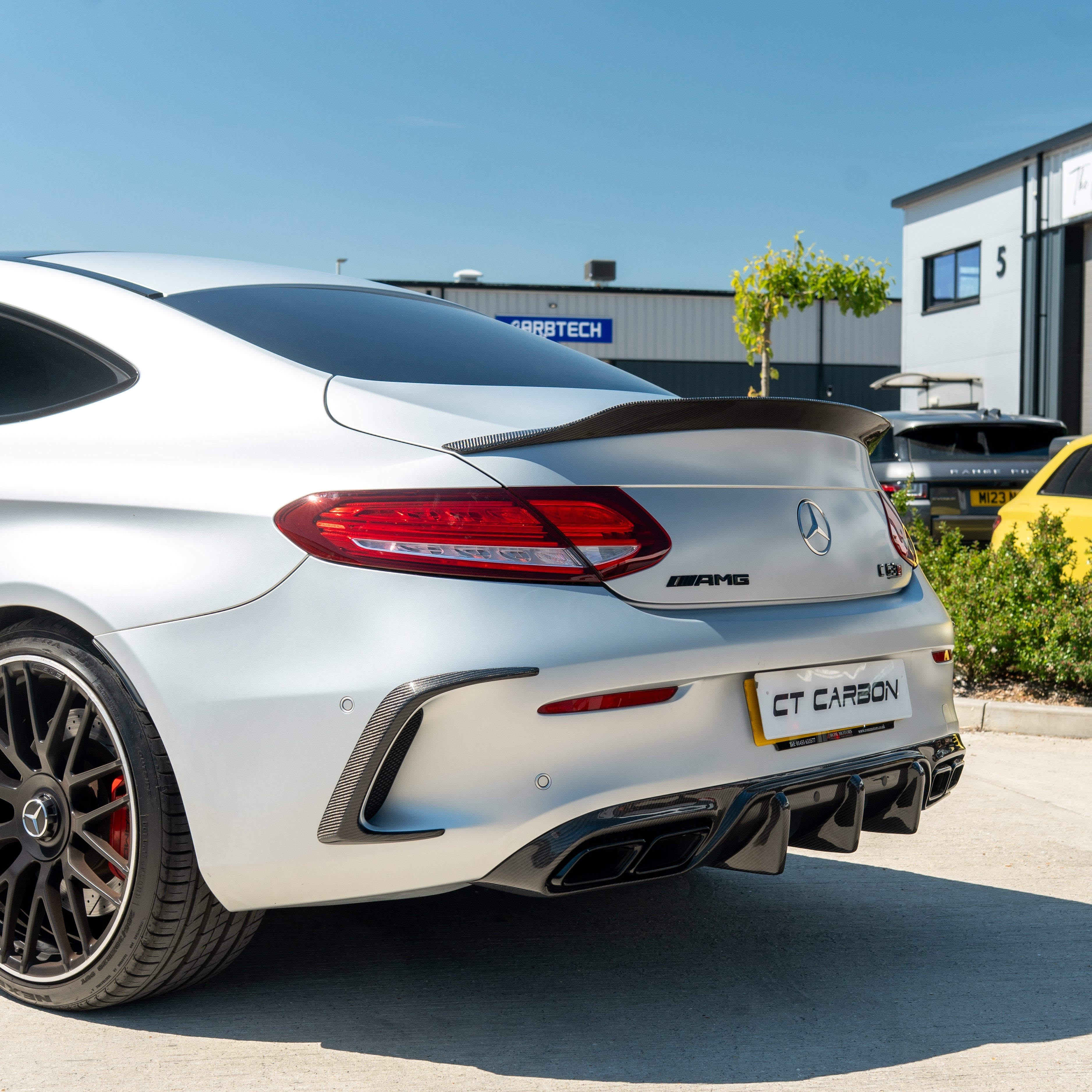 Mercedes C63/C63S W205 coupe carbon spoiler by CT Carbon, showing the sleek black aerodynamic rear spoiler on the vehicle.