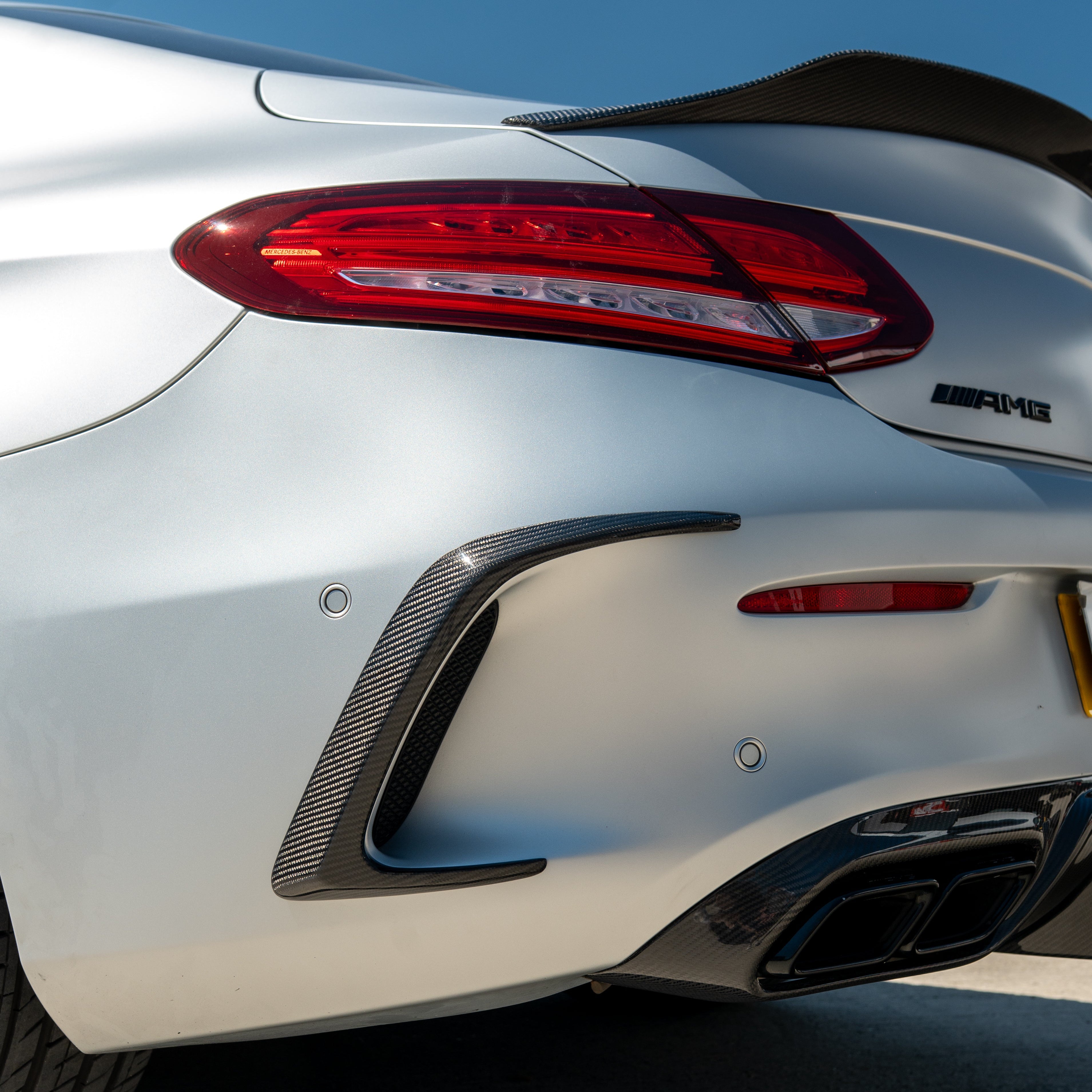 Carbon fiber canards for Mercedes W205 C63 & C63S coupe rear bumper, designed as high-performance accessories by CT Carbon.