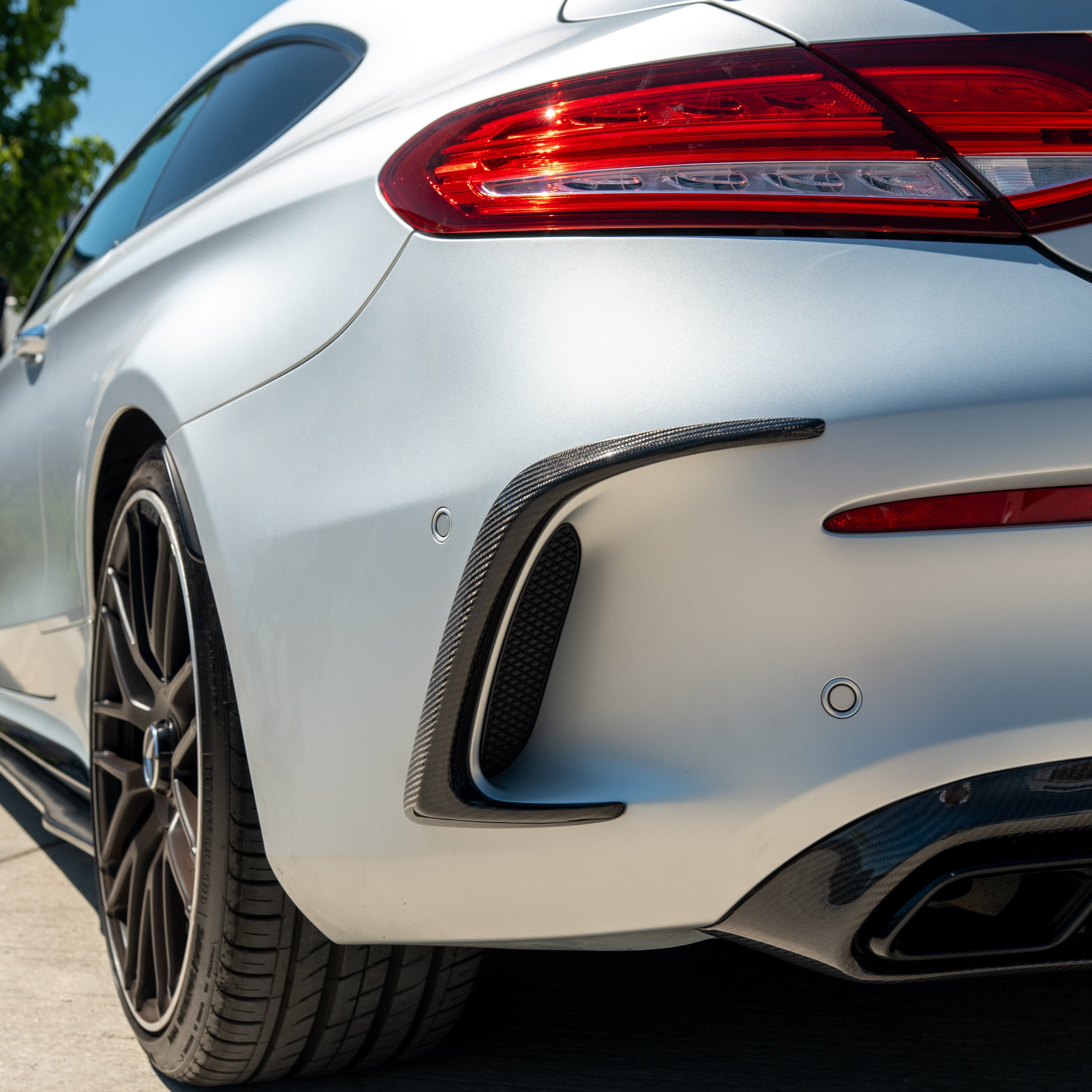 CT Carbon rear bumper carbon fibre canards for Mercedes W205 C63 and C63S coupe, close-up view of aerodynamic car accessories.