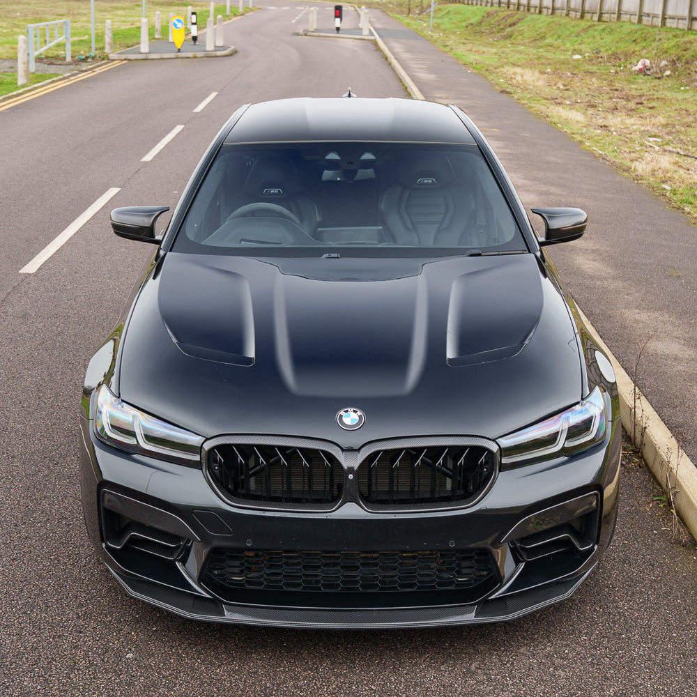 BMW F90 M5 carbon fiber splitter by CT Carbon, close-up view of the sleek, aerodynamic splitter on the car's front.