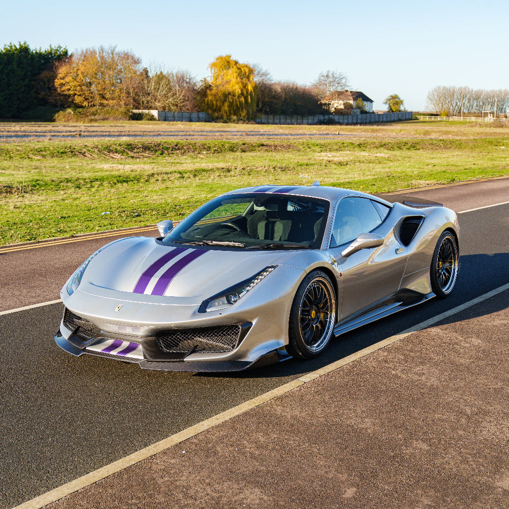 Ferrari 488 Pista carbon fibre side skirts by CT Carbon, showcasing sleek, aerodynamic design on a sports car.