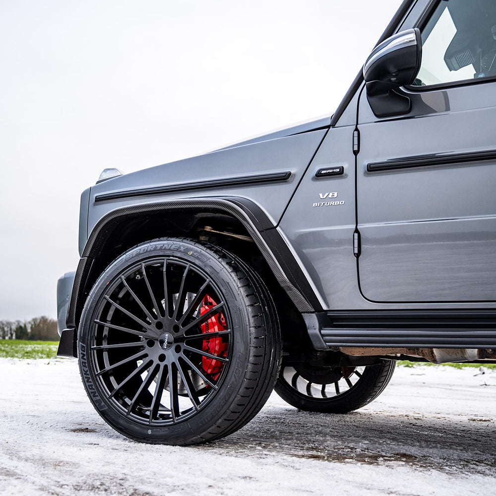 Mercedes-Benz G63 W463 2018-2024 full carbon fiber wide arch kit by CT Carbon, showing the sleek, textured carbon fiber design on the car.
