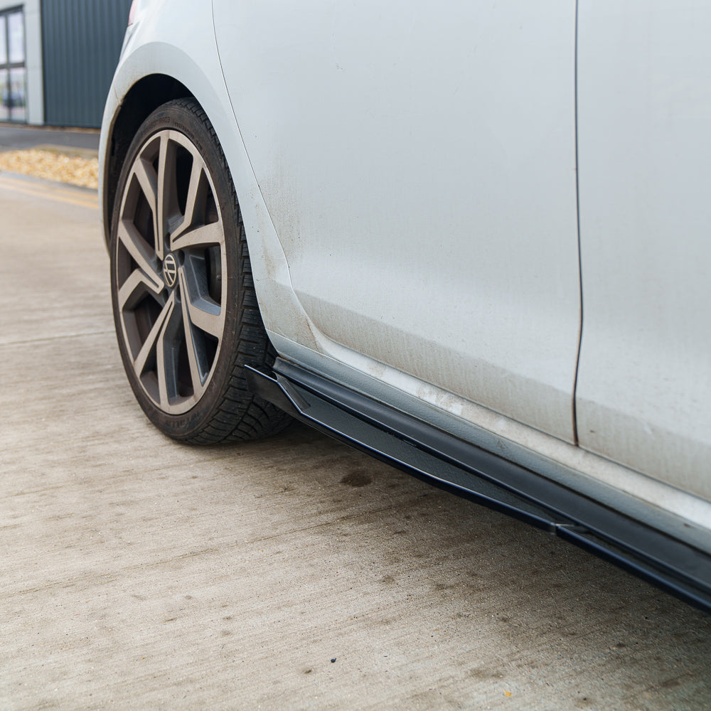 Gloss black side skirts for VW Golf MK7/7.5 GTI R GTD by CT Carbon, showcasing sleek, aerodynamic design on a 2014-2020 model.