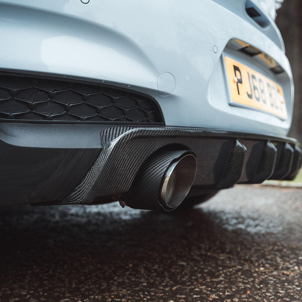 HYUNDAI I30N CT Carbon carbon fiber exhaust tips installed on the vehicle's rear, showcasing sleek, glossy finish and durable design.