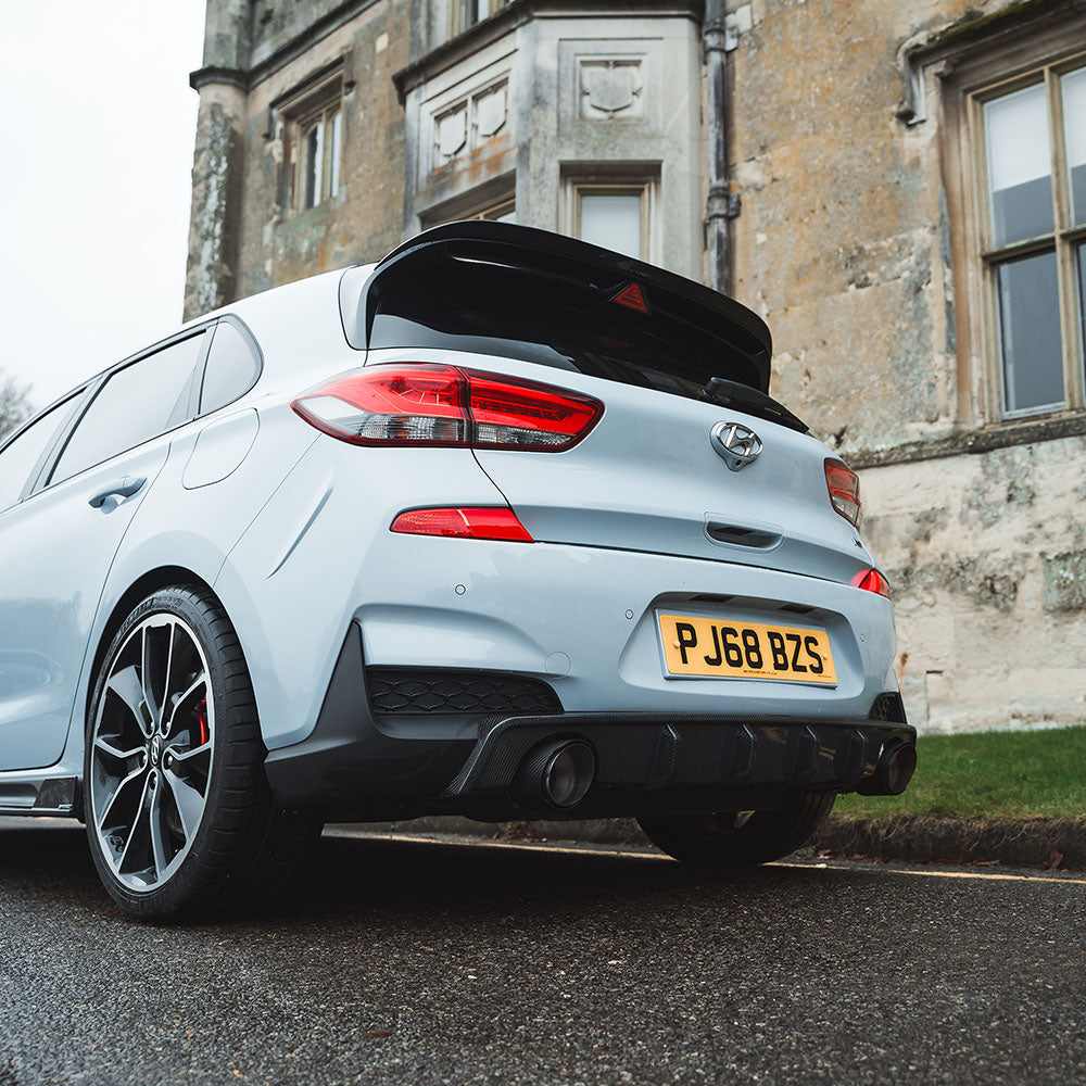 HYUNDAI I30N CT Carbon carbon fibre exhaust tips installed on the vehicle showing sleek, shiny finish and sporty design.