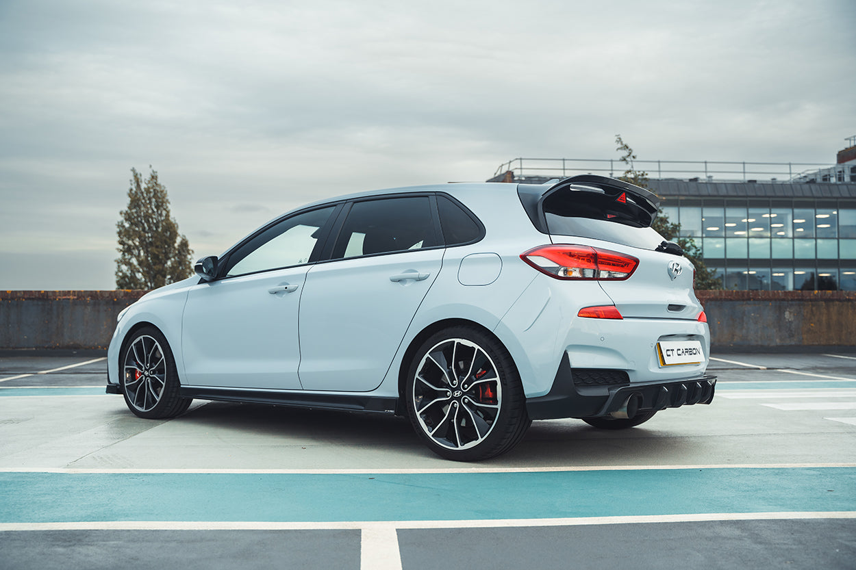 Hyundai i30N carbon fibre kit by CT Design, pre-facelift model, showing sleek carbon fibre details on car accessories.