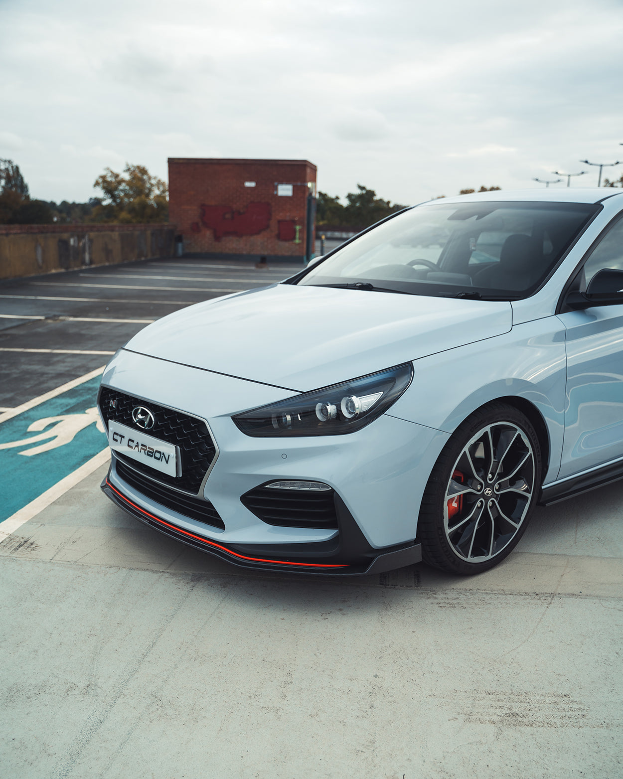 HYUNDAI i30N front carbon fiber splitter by CT Design, showcasing sleek aerodynamic design on a pre-facelift model.