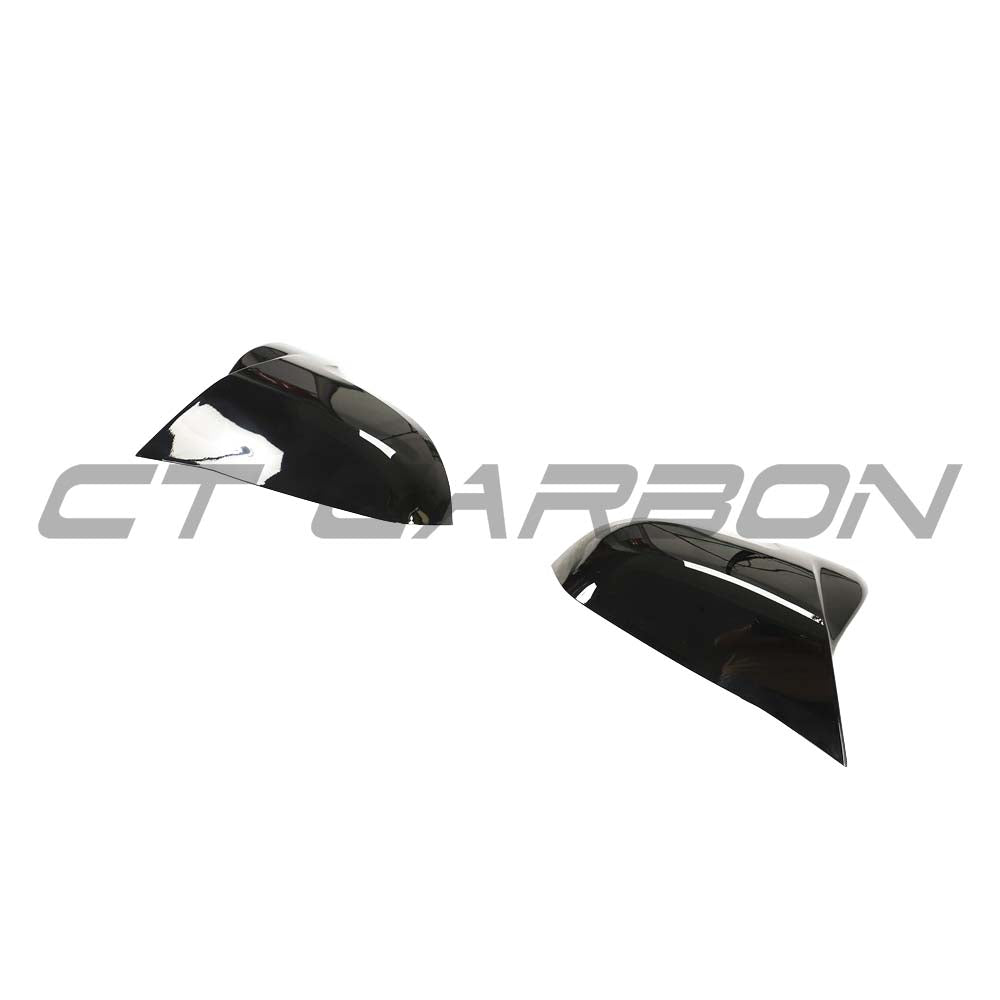 BMW F40/F44 1 and 2 Series replacement gloss black mirror covers by CT Carbon, showing sleek, aerodynamic design on the car mirrors.
