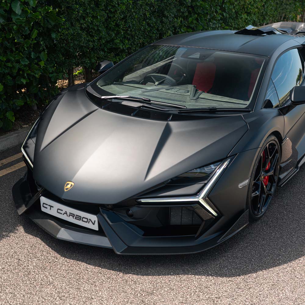Lamborghini Revuelo full carbon fiber kit by CT Carbon, showing detailed carbon fiber components on a sleek sports car.